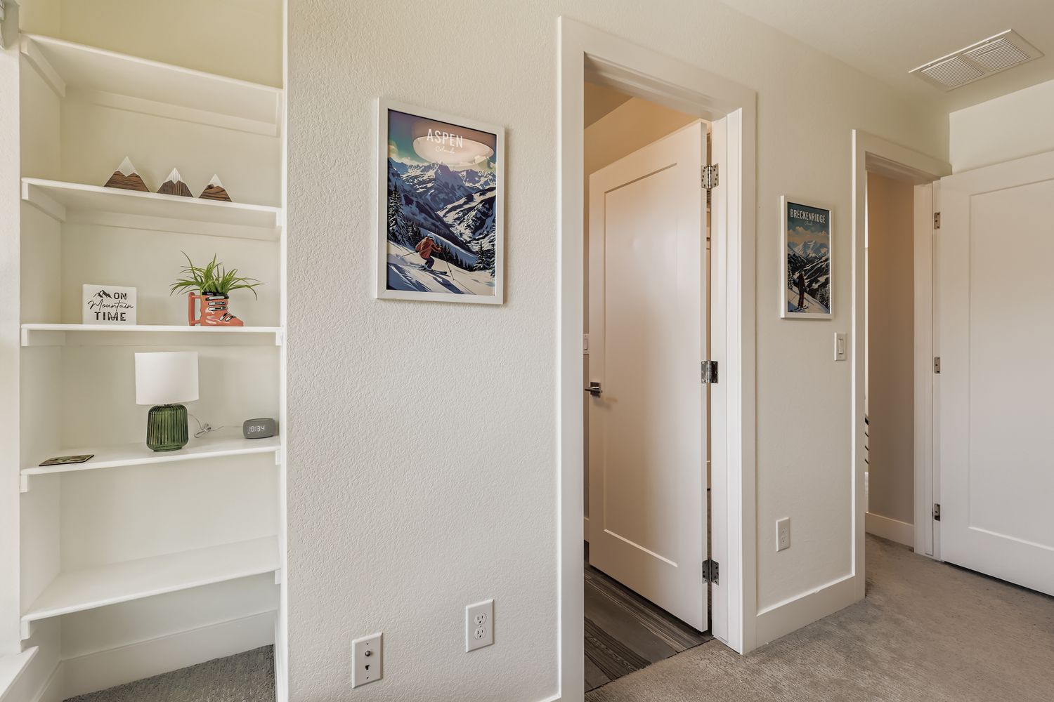 Thoughtful built-in shelving creates perfect spots for your personal touches, while ski-themed artwork adds alpine charm to your cozy retreat.