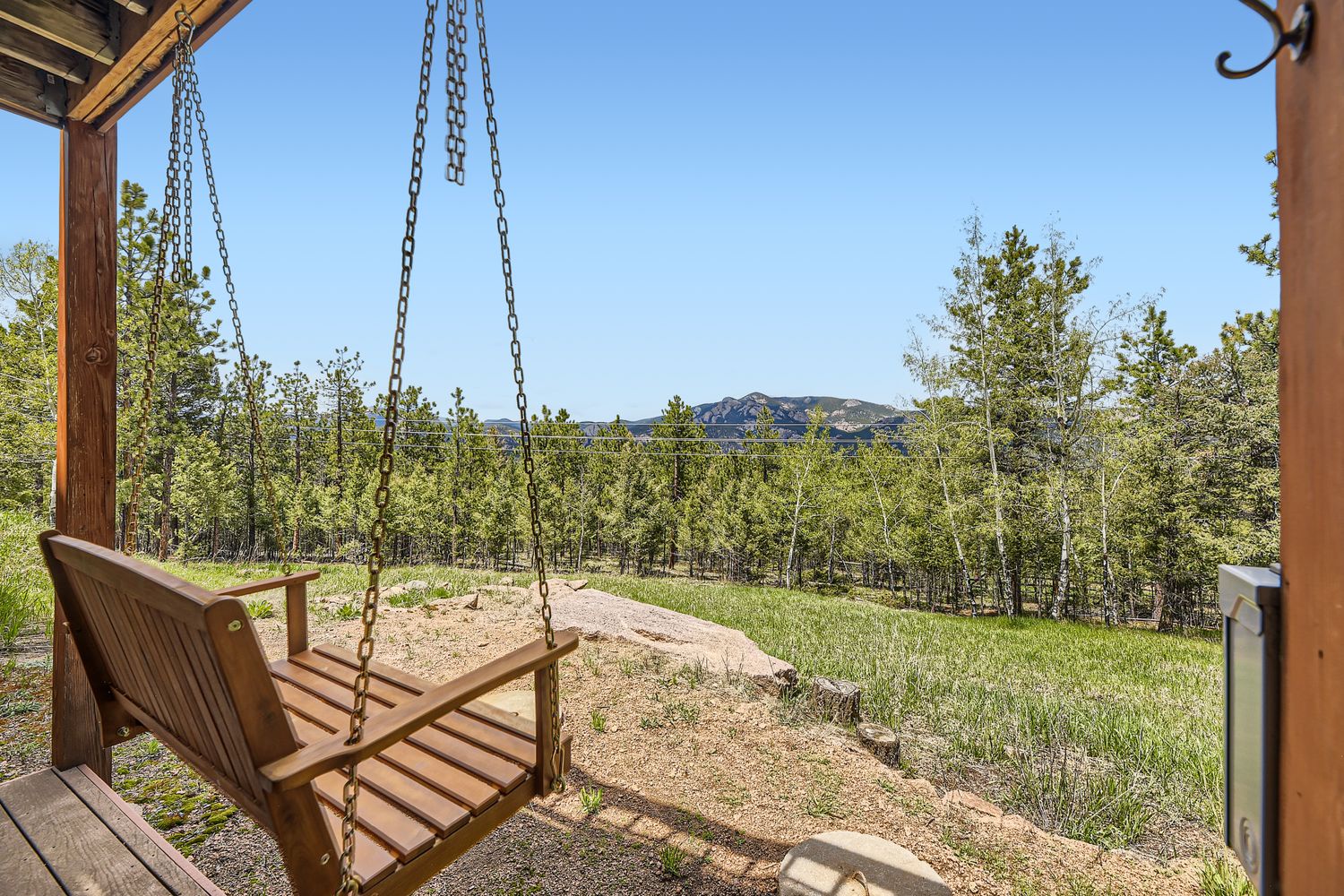 Unwind on your private porch swing with breathtaking mountain views stretching across rolling hills and forest.
