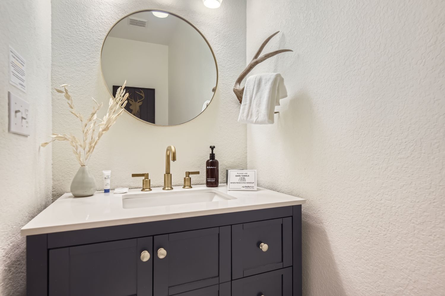Indulge in your private bathroom sanctuary with elegant brass fixtures, thoughtful amenities, and stylish touches that make your morning routine a luxury.