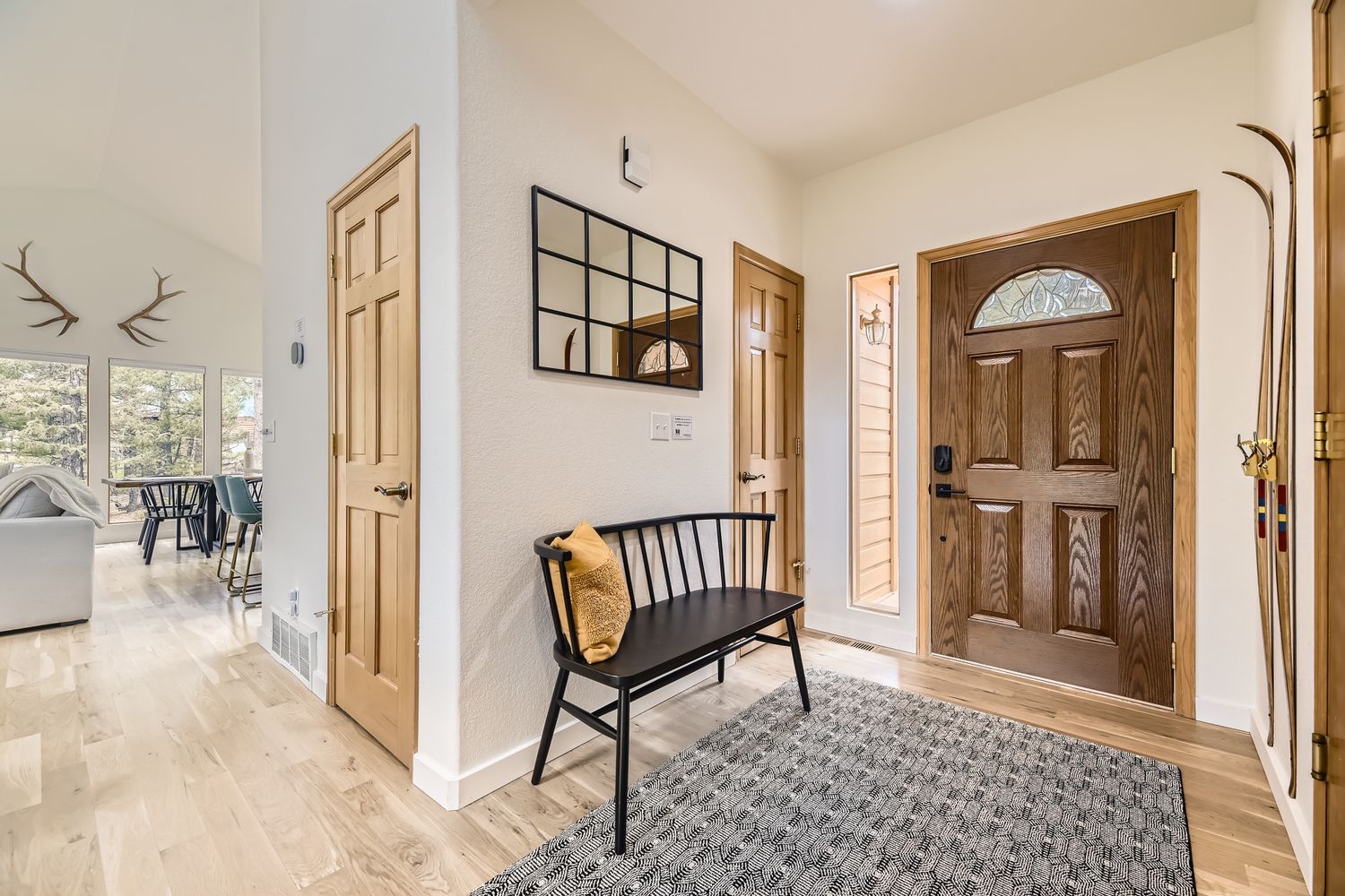 Step into your welcoming entryway with warm wood accents and a cozy bench to slip off your shoes after exploring.