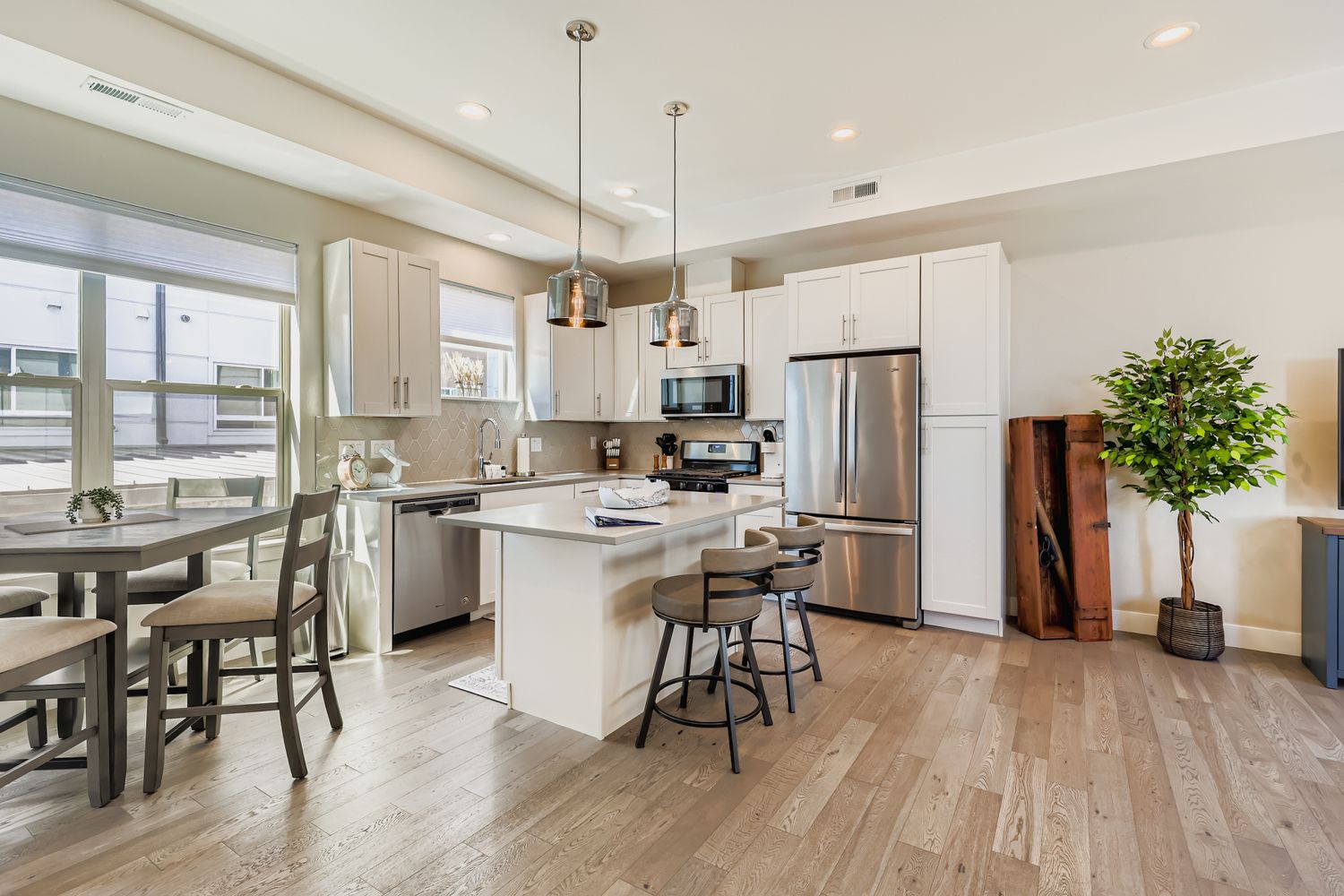Your bright, modern kitchen invites culinary adventures with stainless steel appliances, sleek white cabinets, and a convenient breakfast bar for morning coffee.
