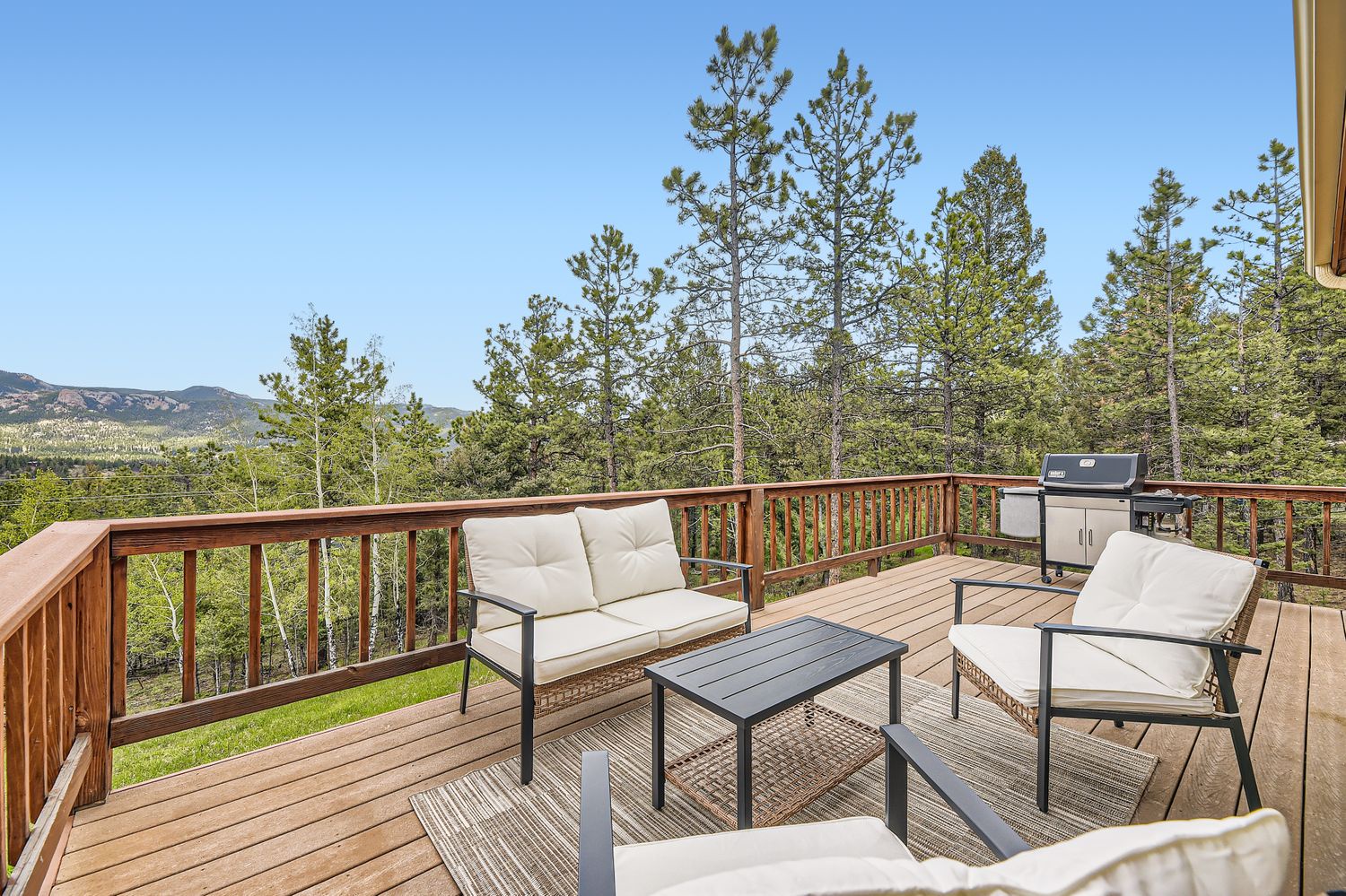 Relax on your private deck with stunning mountain views, comfortable seating, and BBQ for perfect outdoor moments.