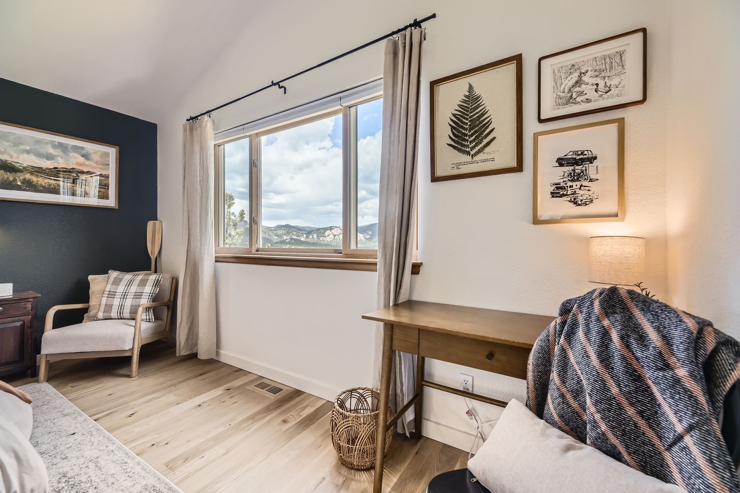 Unwind in your cozy living space with stunning mountain views, thoughtful artwork, and comfortable seating perfect for relaxing after adventures.