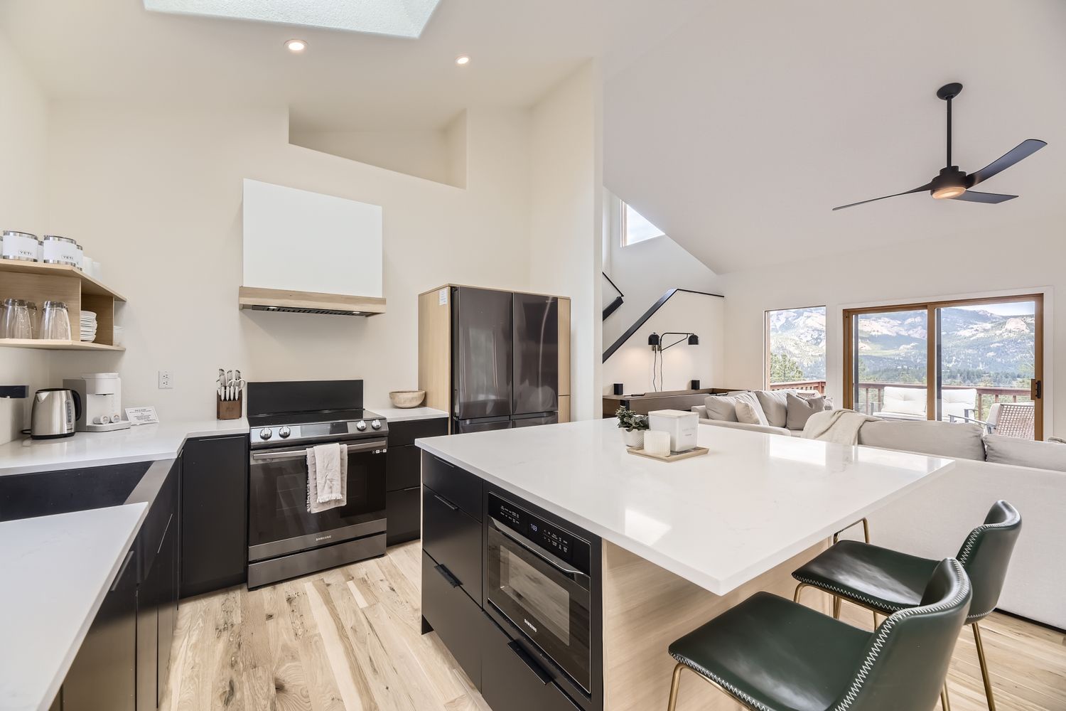 Your modern kitchen flows seamlessly into the living area, where mountain views frame every meal you prepare.