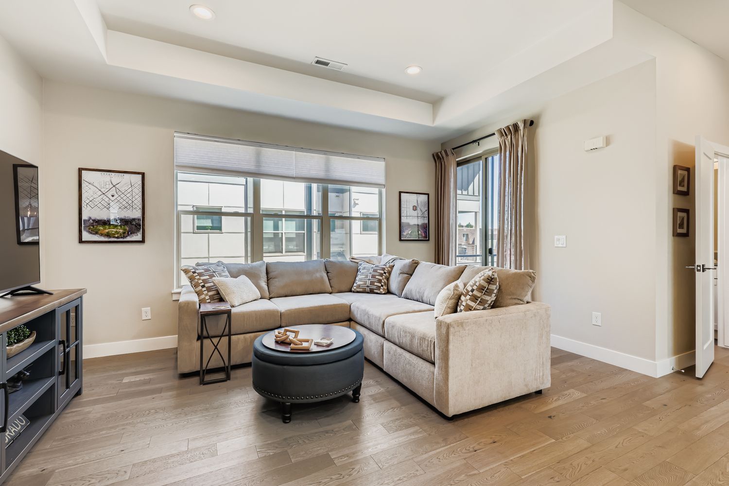 Sink into this luxurious sectional sofa where natural light streams through oversized windows, creating your perfect spot for morning coffee or evening relaxation.