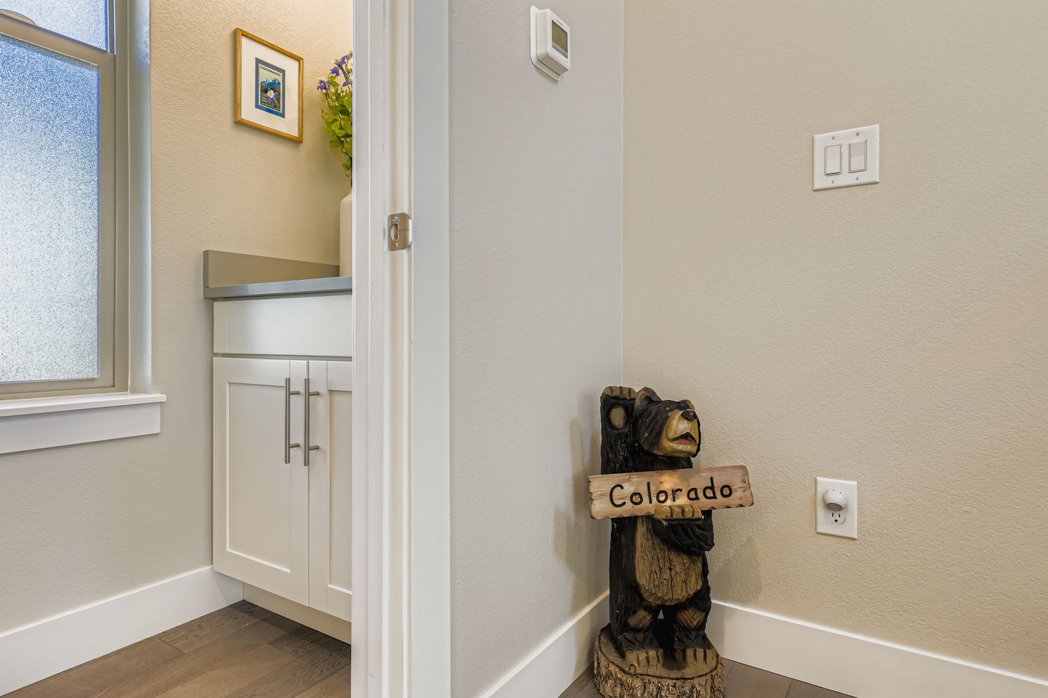 Step into your cozy Colorado retreat where charming touches like this friendly bear welcome you home after mountain adventures.