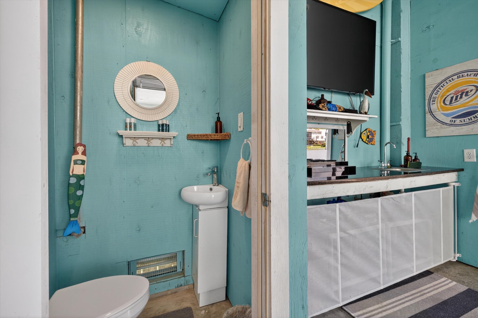 Step into a charming turquoise retreat with beach vibes.