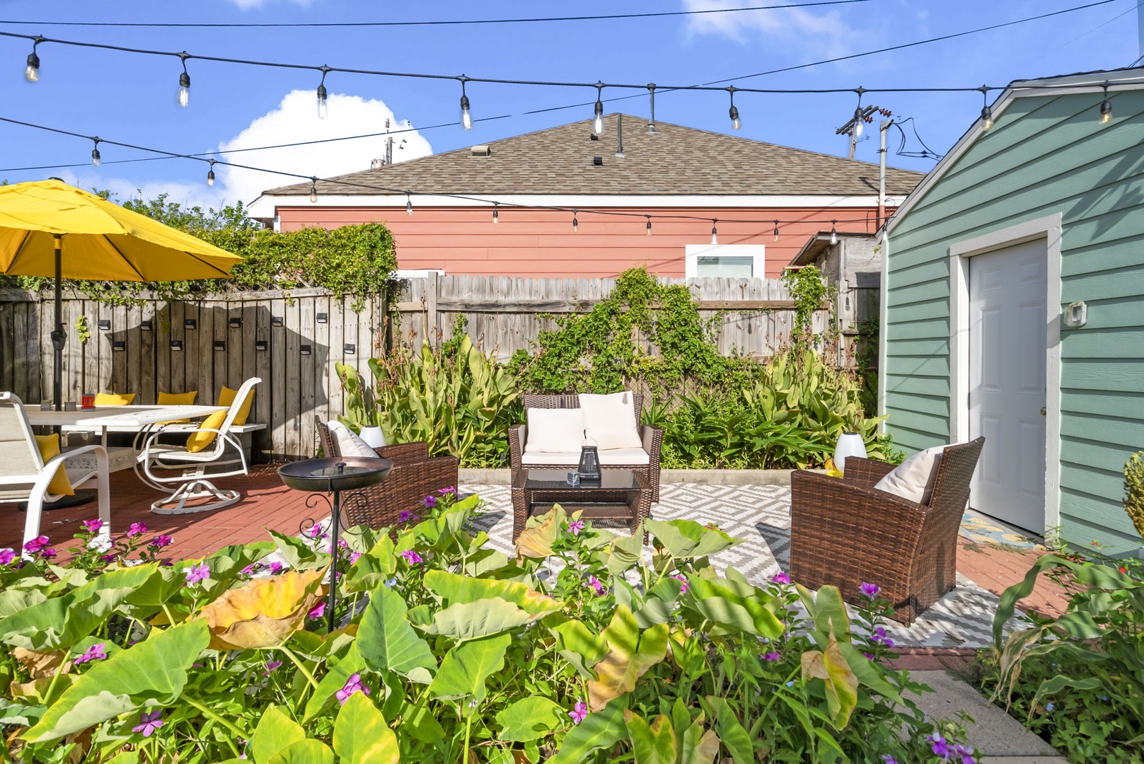Private outdoor oasis with plants and cozy seating.