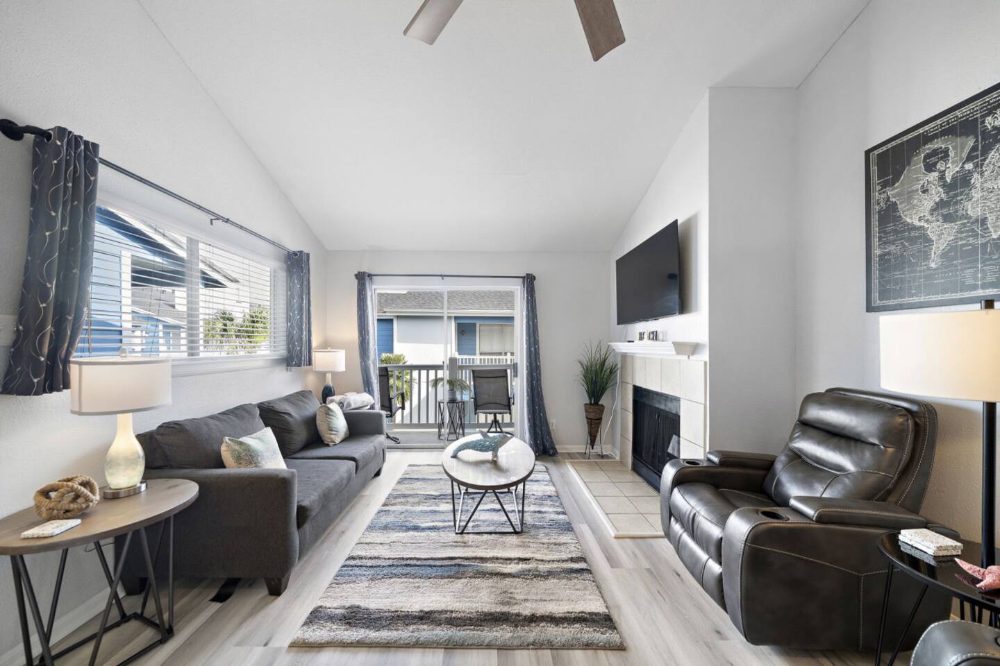 Cozy living room with fireplace & balcony views