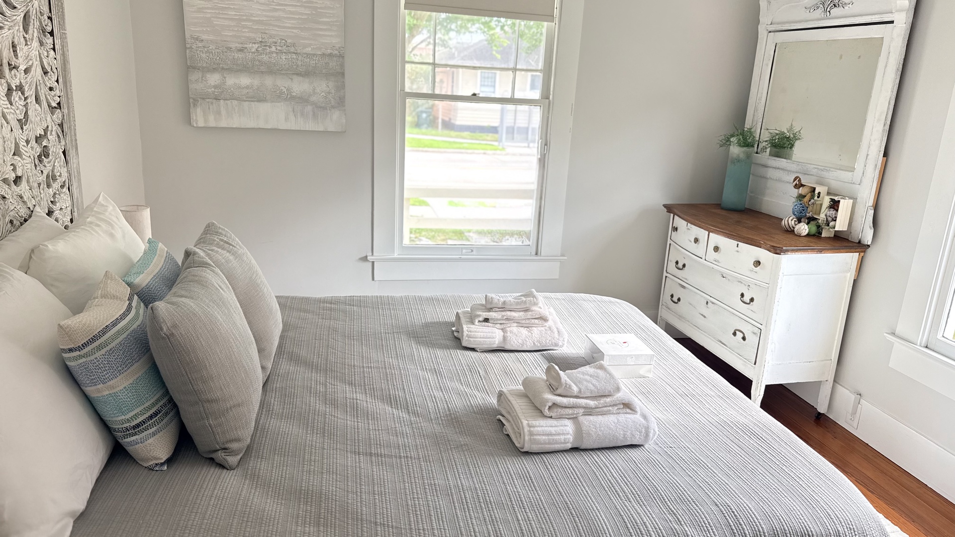 Your serene bedroom offers soft linens, natural light, and a peaceful street view—perfect for winding down after a day of exploring.