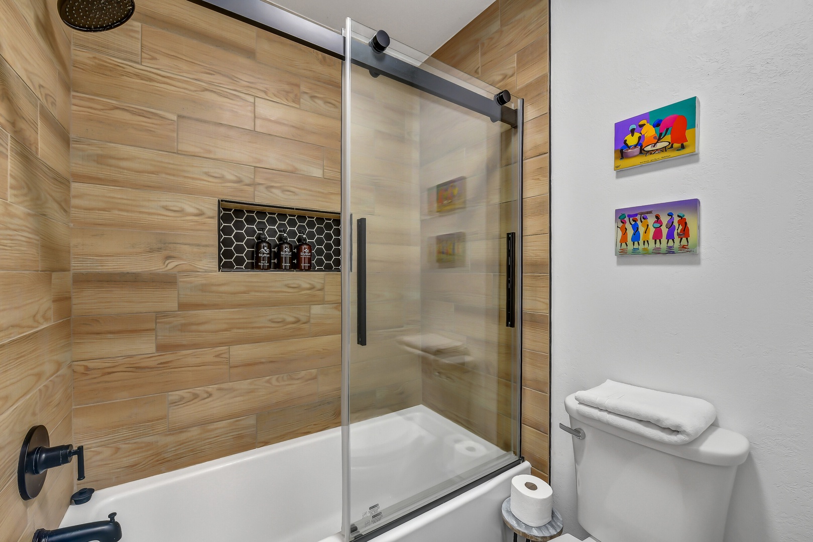 Sleek shower with wood-look tile and built-in niches