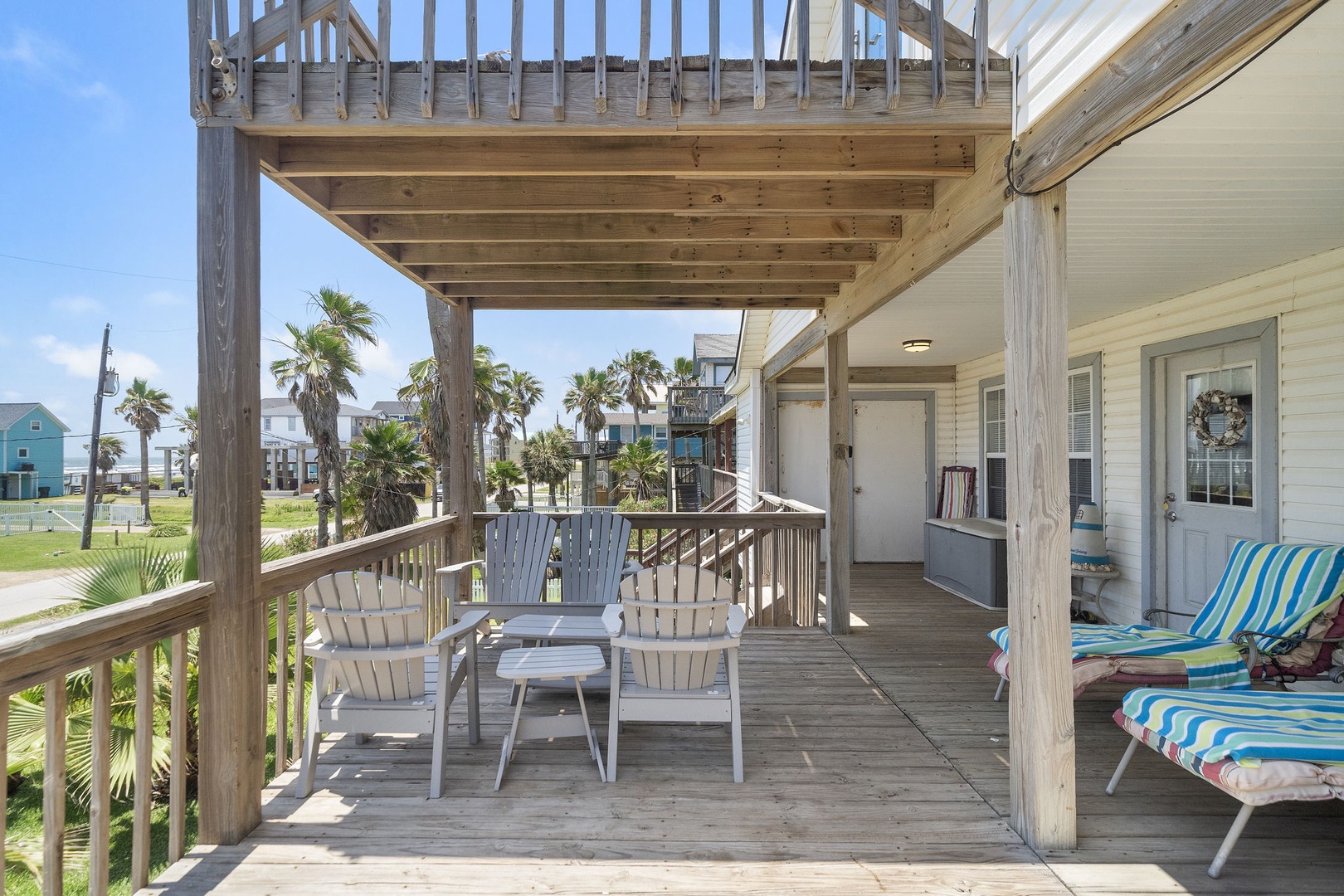 Step onto your private deck and breathe in the salty sea air as you relax in comfortable outdoor seating. Palm trees sway gently in the yard while you sip your morning coffee or unwind after a beach day.