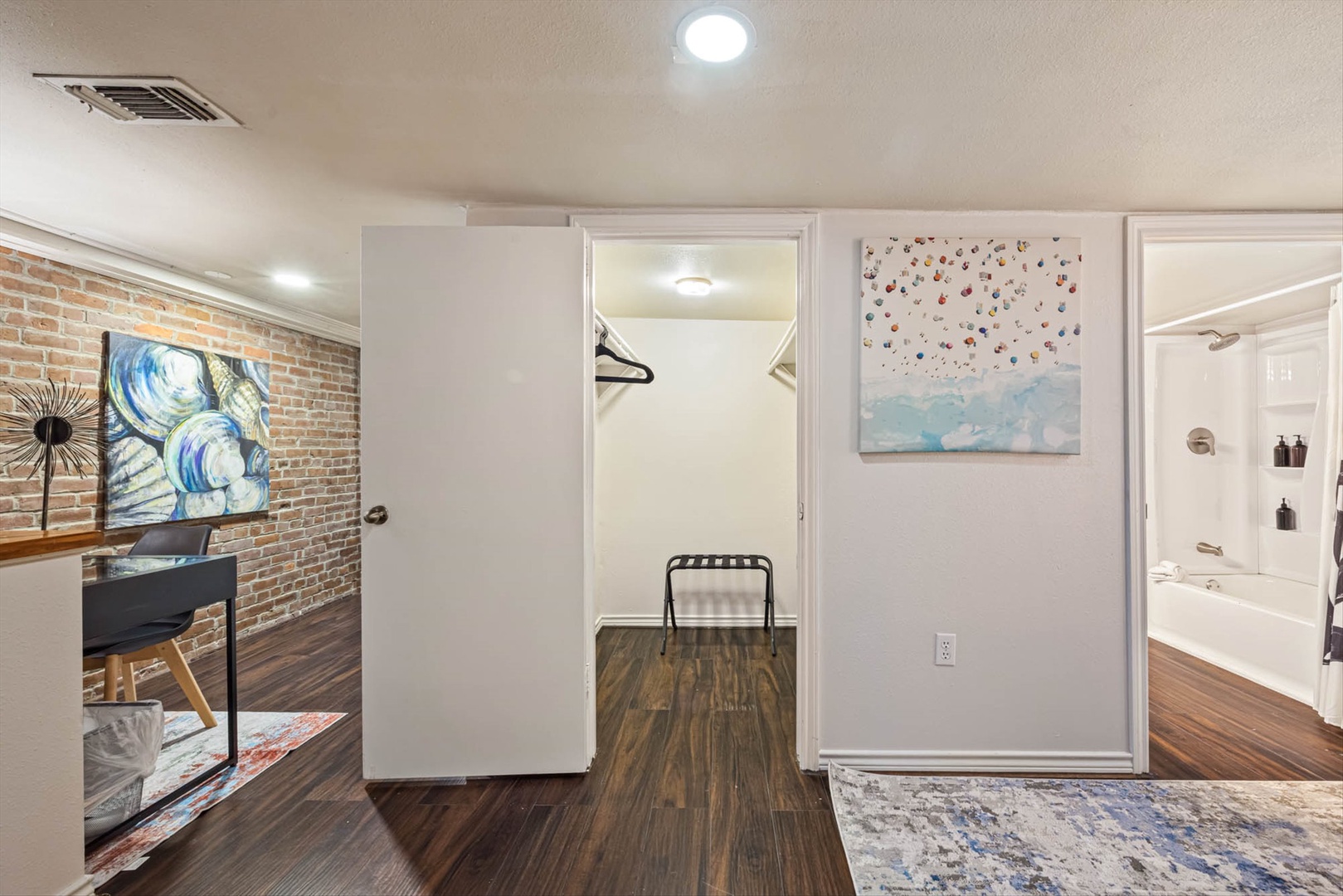 Private walk-in closet with shelving and hanging space.