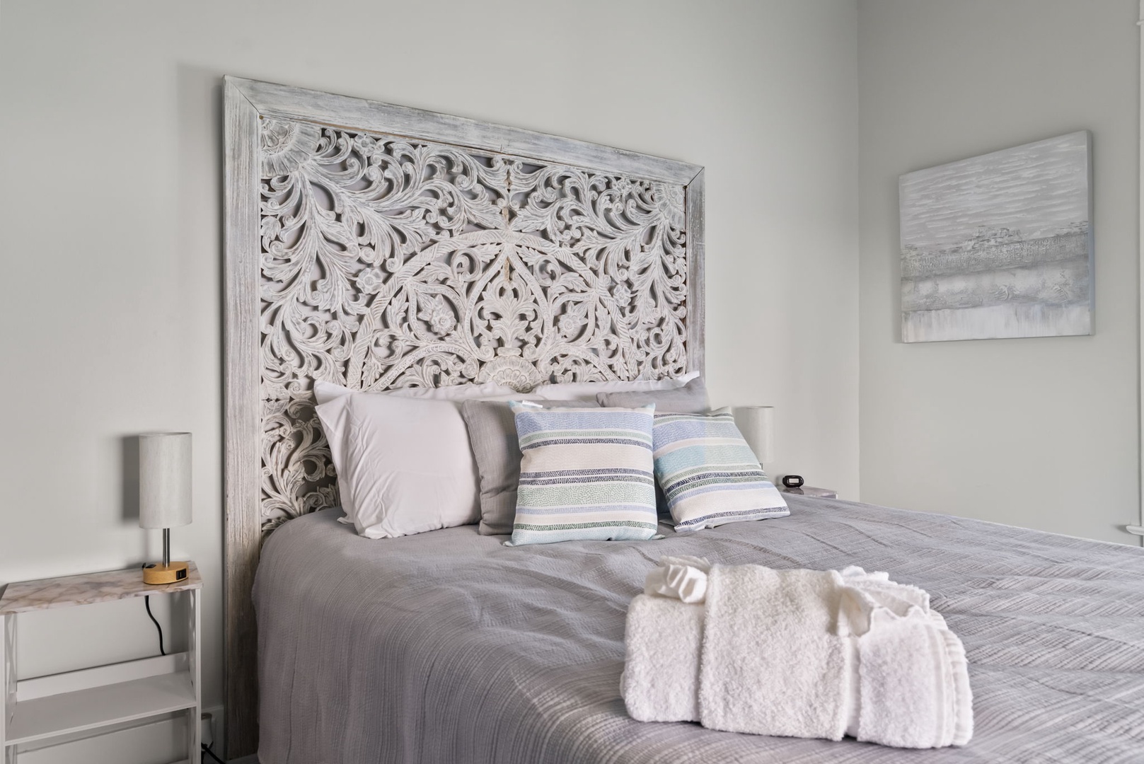 Drift off with carved headboard, soft linens, and plush towels.