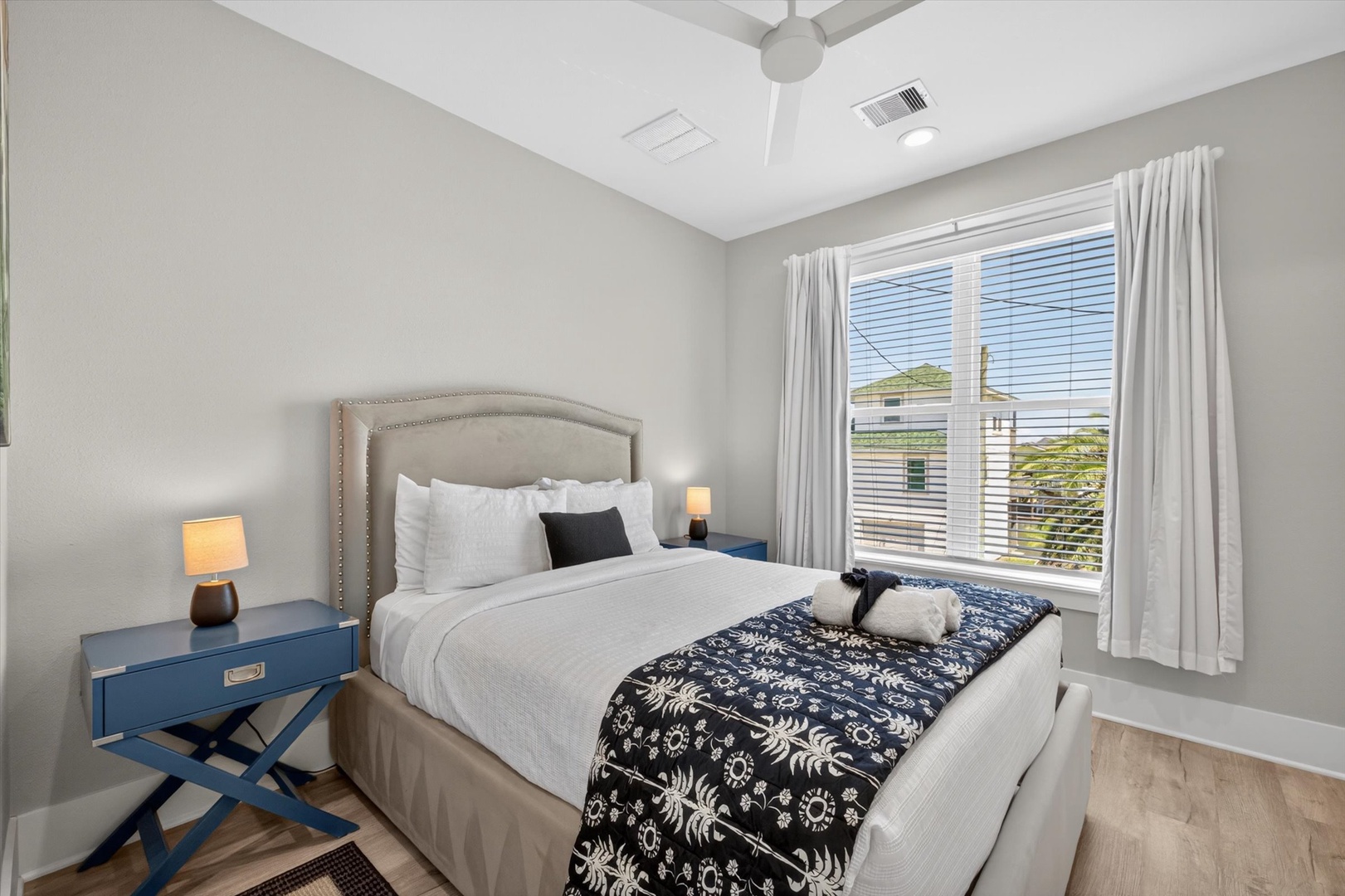 Coastal bedroom retreat with soft light and comfort.