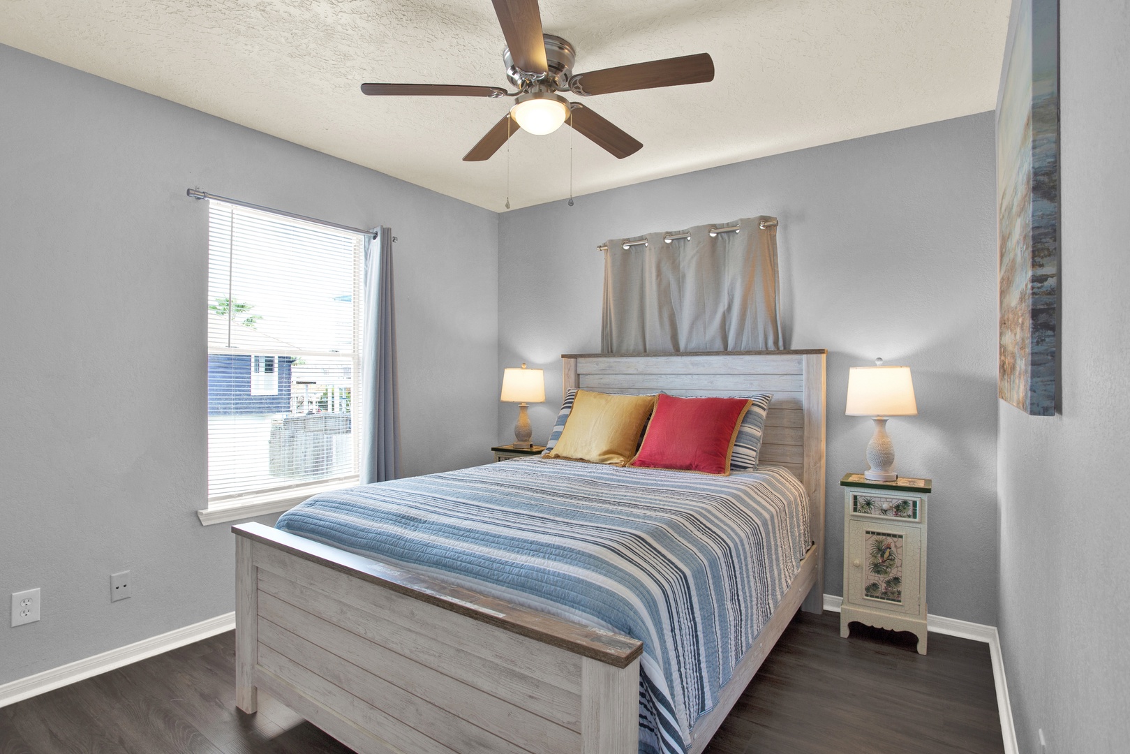 Drift off in your peaceful bedroom, where soft gray tones and coastal-inspired decor create the perfect retreat after a day of adventure.
