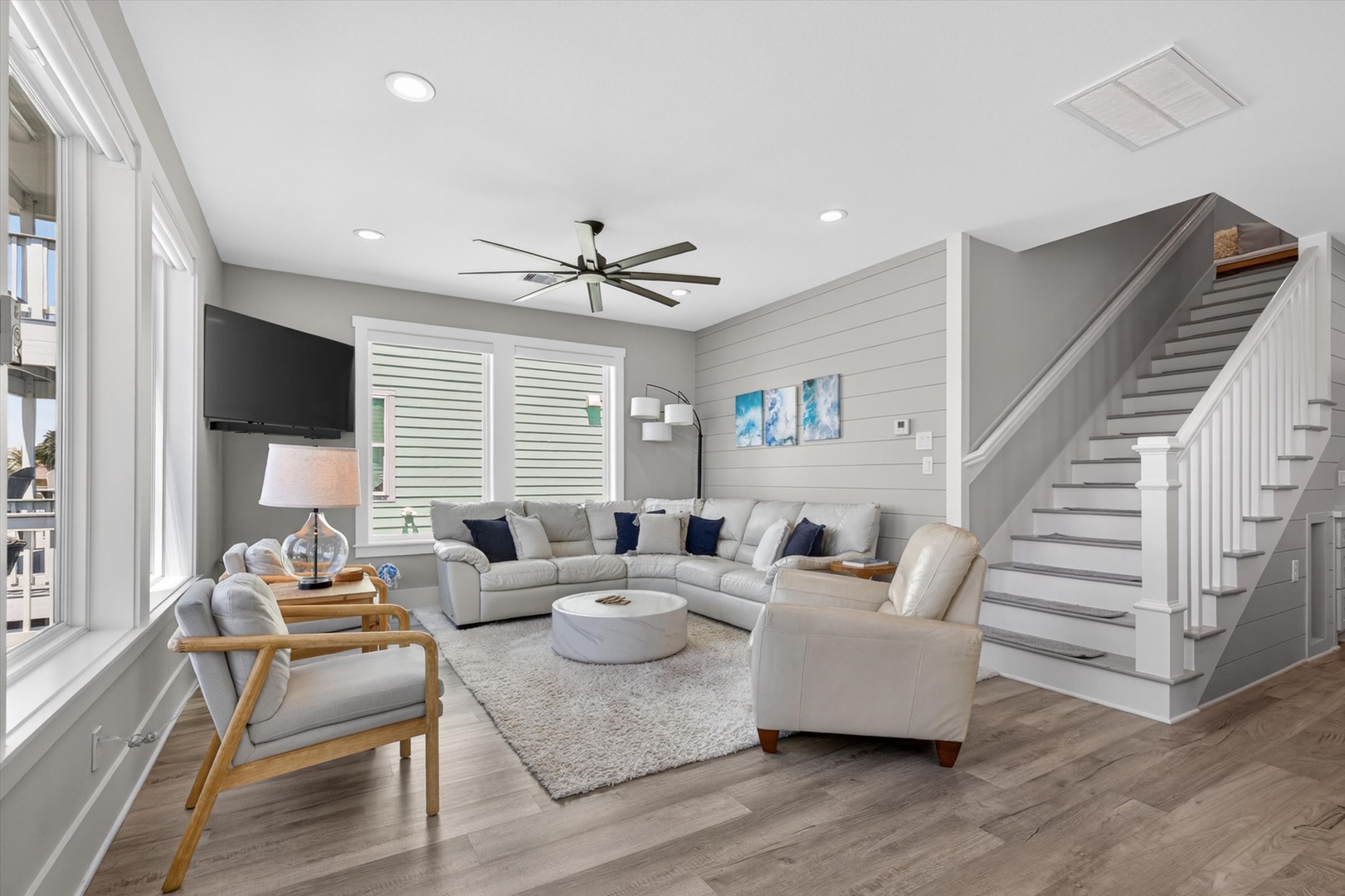 Bright, airy living room with shiplap and plush seating.