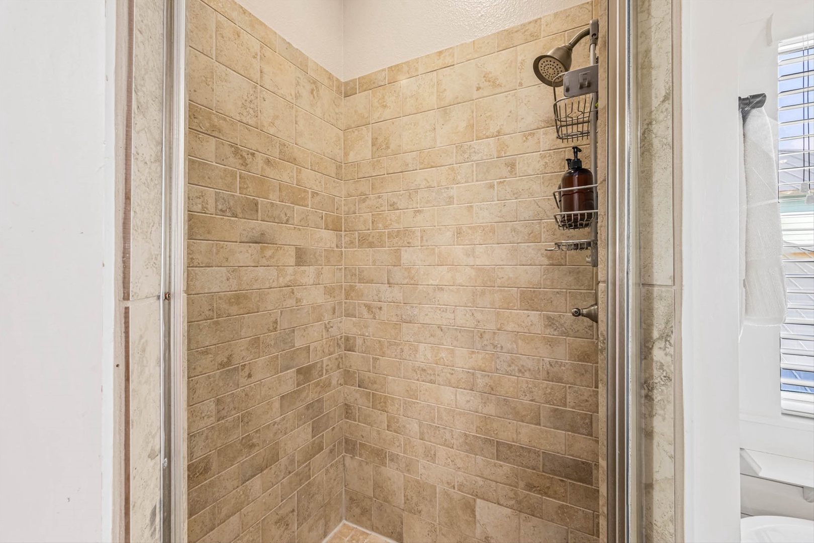 Tiled shower with rainfall head for a perfect refresh.