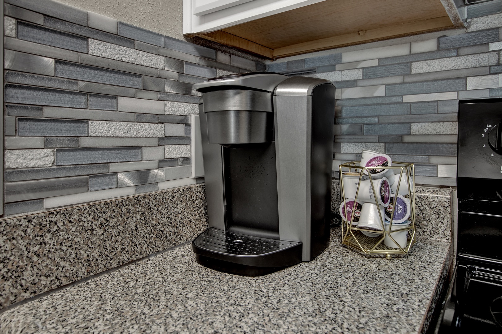 Coffee station with granite counters and modern tile