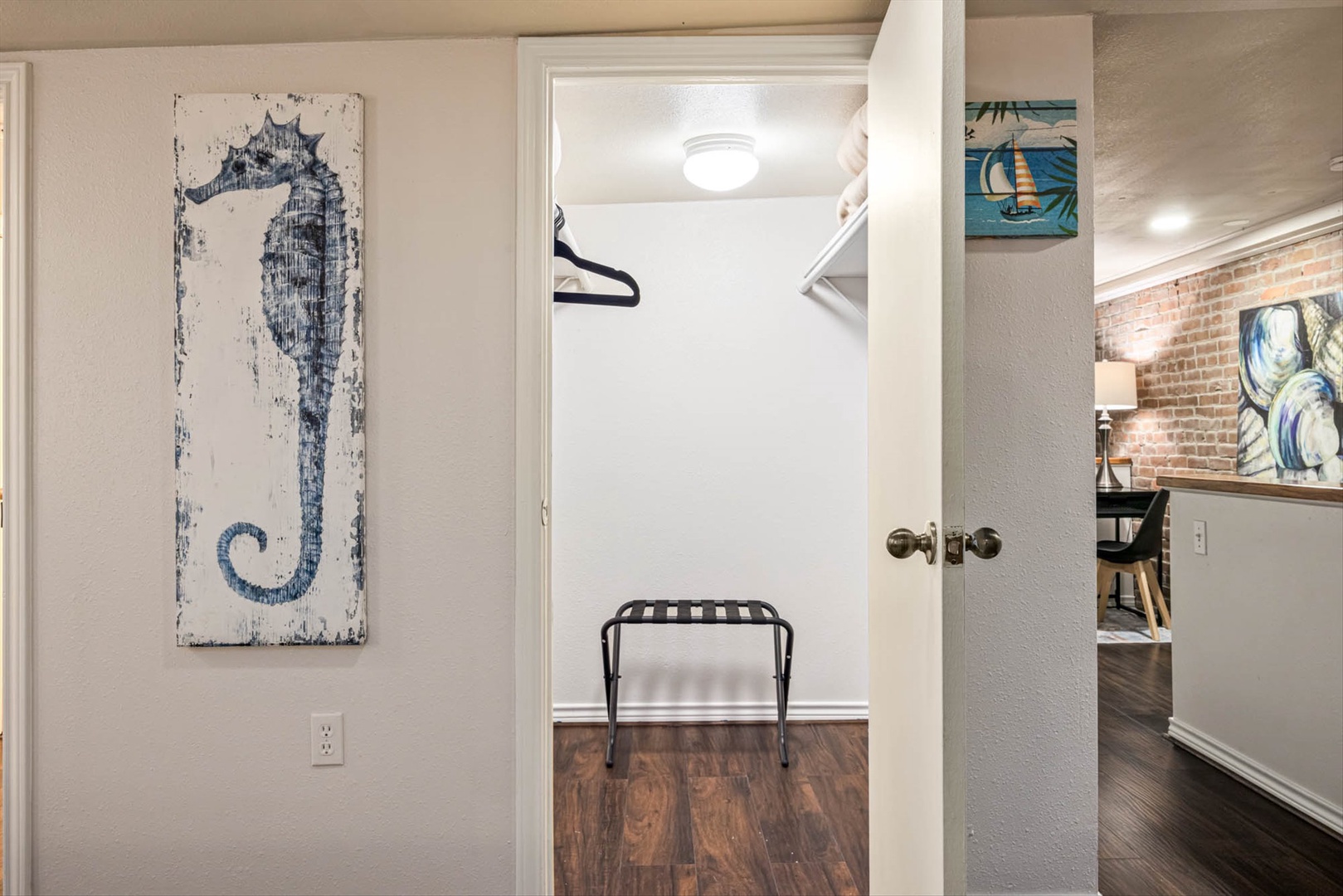 Welcoming coastal retreat with nautical art and wood floors.