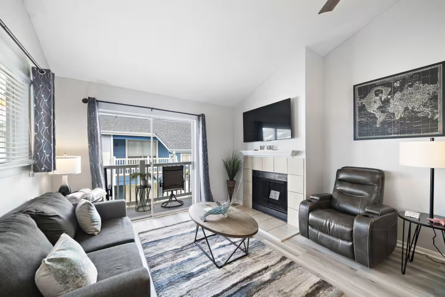 Spacious living room with fireplace & balcony views