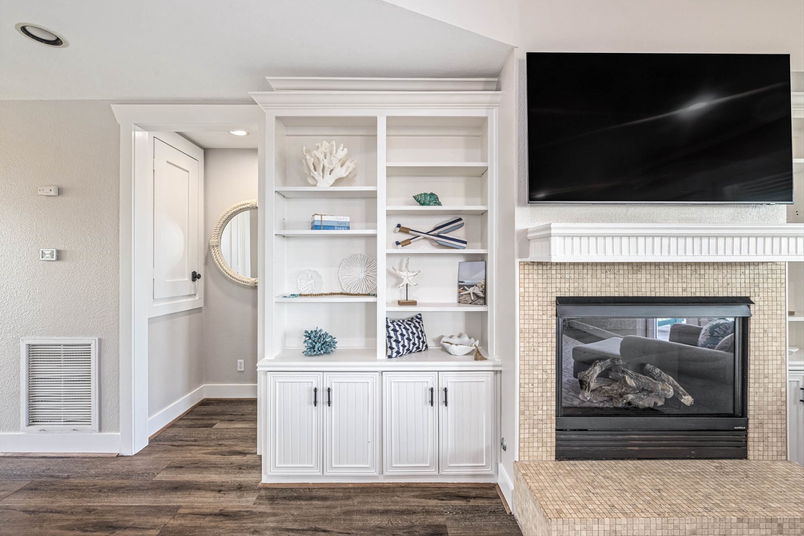 Elegant living space with coastal décor and cozy fireplace.