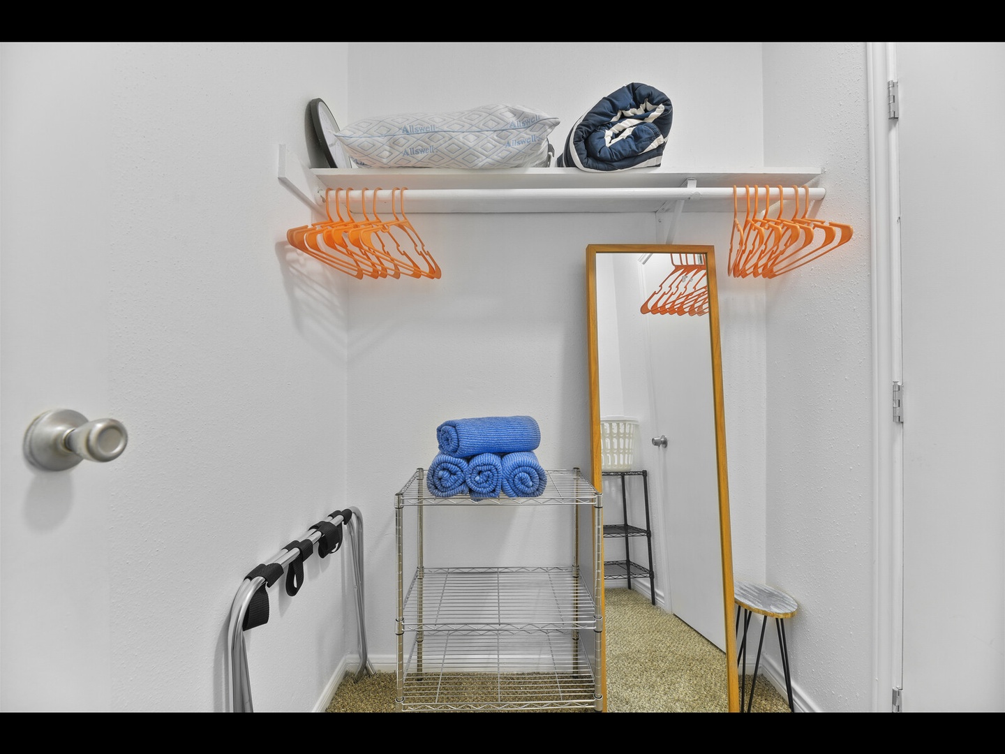 Walk-in closet with organized storage & towels