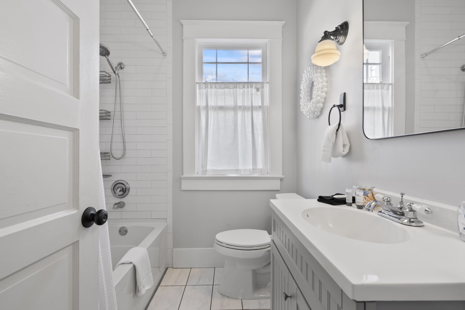 Pristine bathroom with deep tub and refreshing shower.