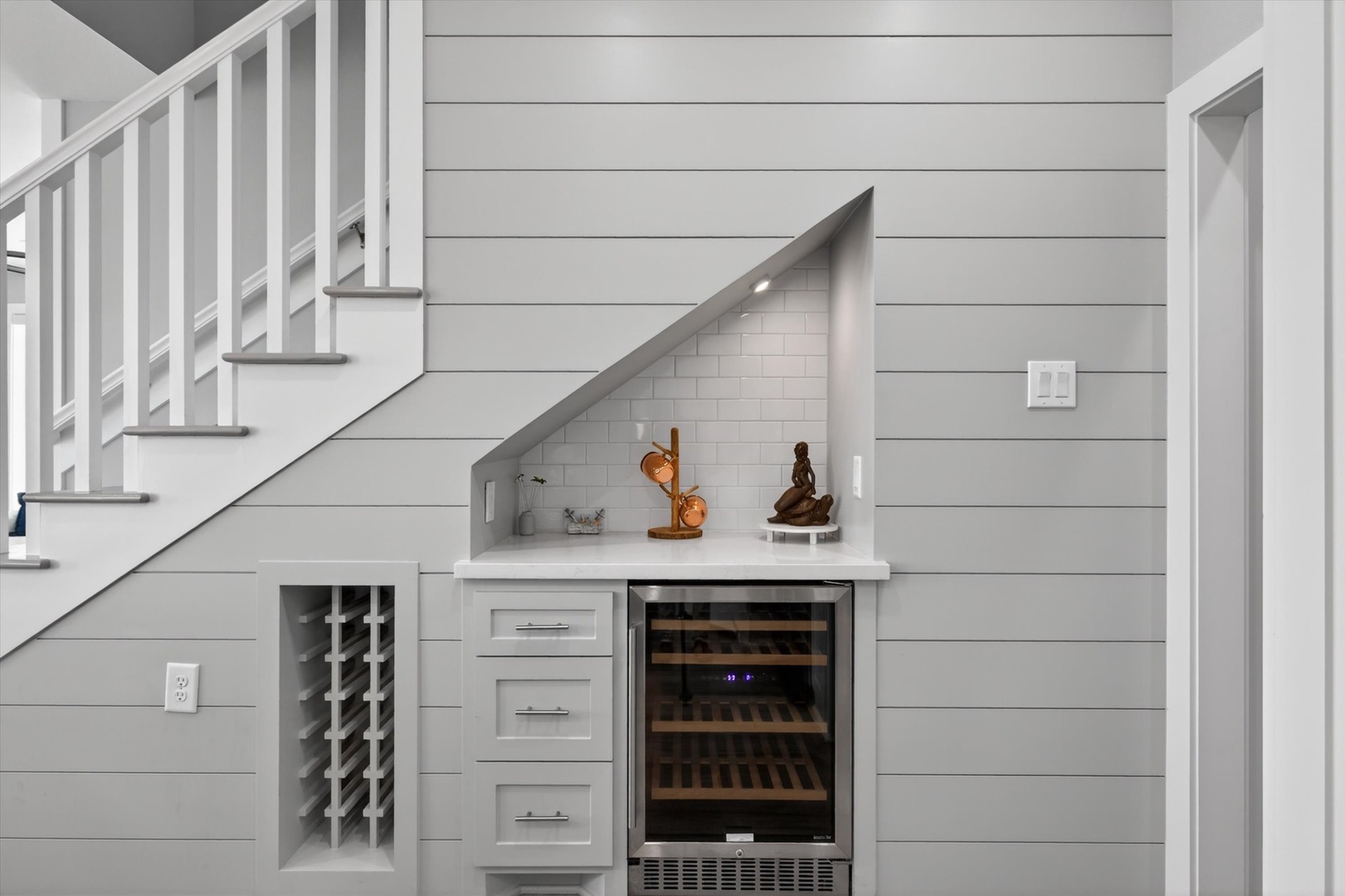 Stylish wine bar with cooler and built-in wine rack.