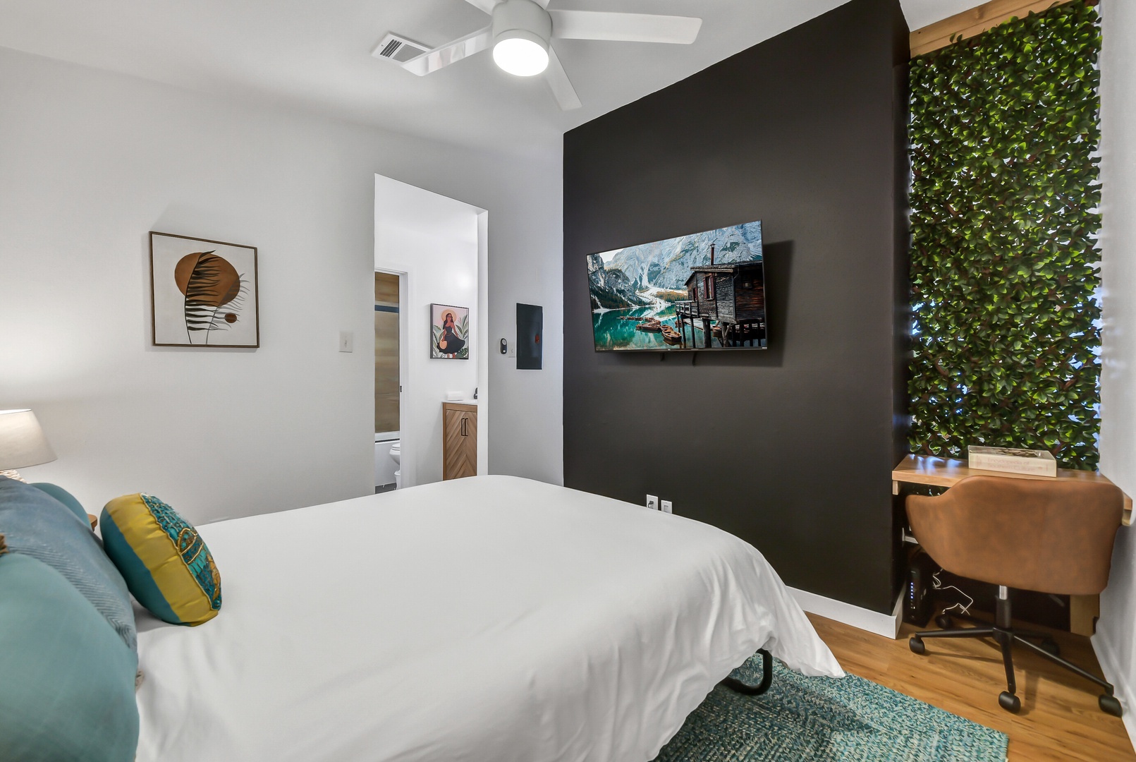 Modern bedroom with crisp linens and a living green wall