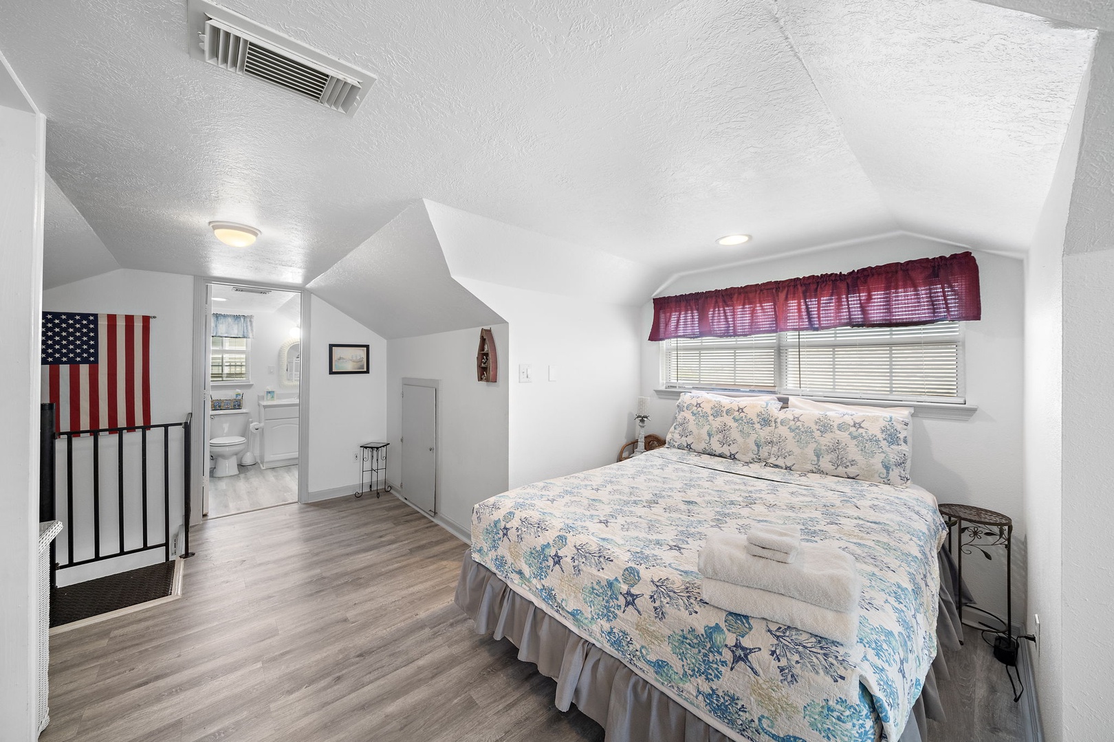 Cozy upstairs retreat with cheerful beach themed bedding  - your perfect hideaway with easy access to the full bath upstairs.