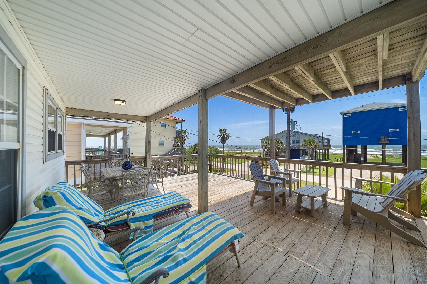 Your spacious covered deck awaits with lounge chairs and comfortable seating where you can soak up ocean breezes and coastal views all day long.