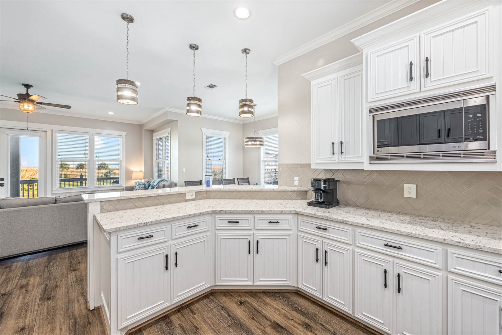 Modern kitchen with granite counters and stainless steel tools.