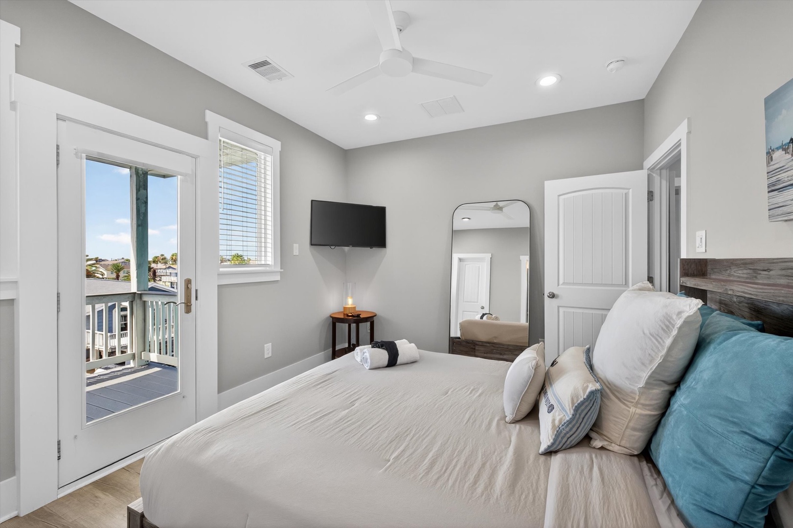 Private balcony access from a serene coastal bedroom.