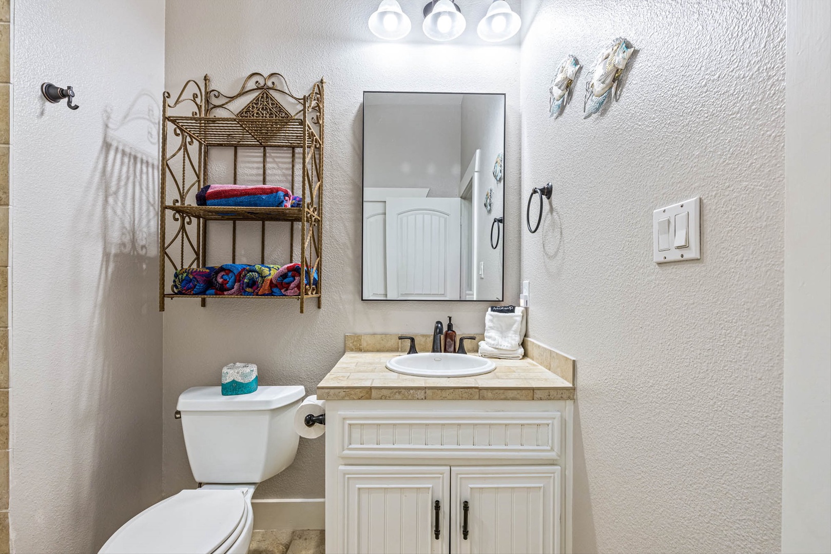 Upstairs shared full bath with vanity and fresh towels.