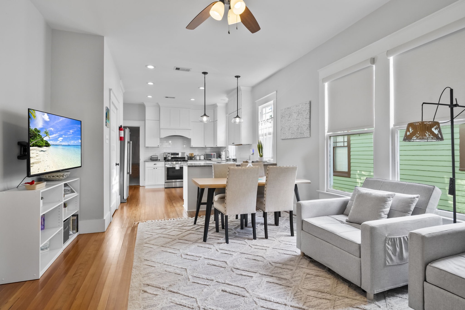 Bright open living with seating, kitchen, and dining for six.