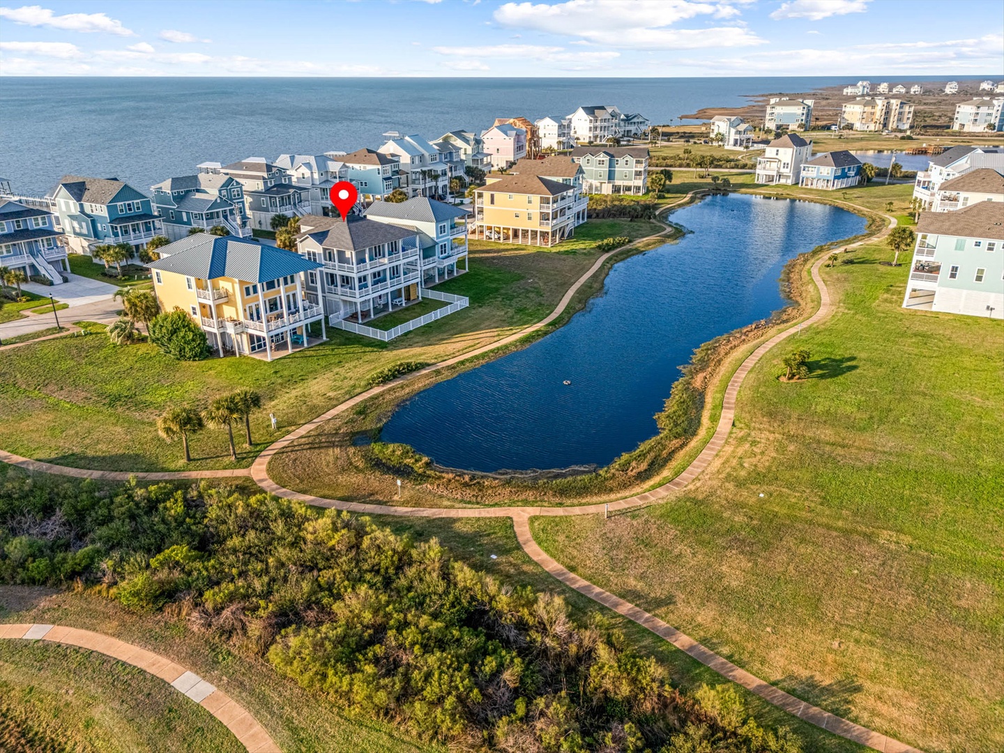 Waterfront community with pond, trails, and ocean nearby.