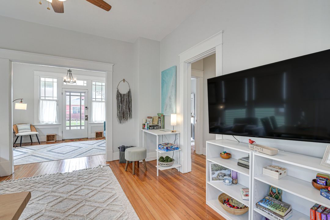 Bright open living space with dedicated work space and art therapy supplies, TV.