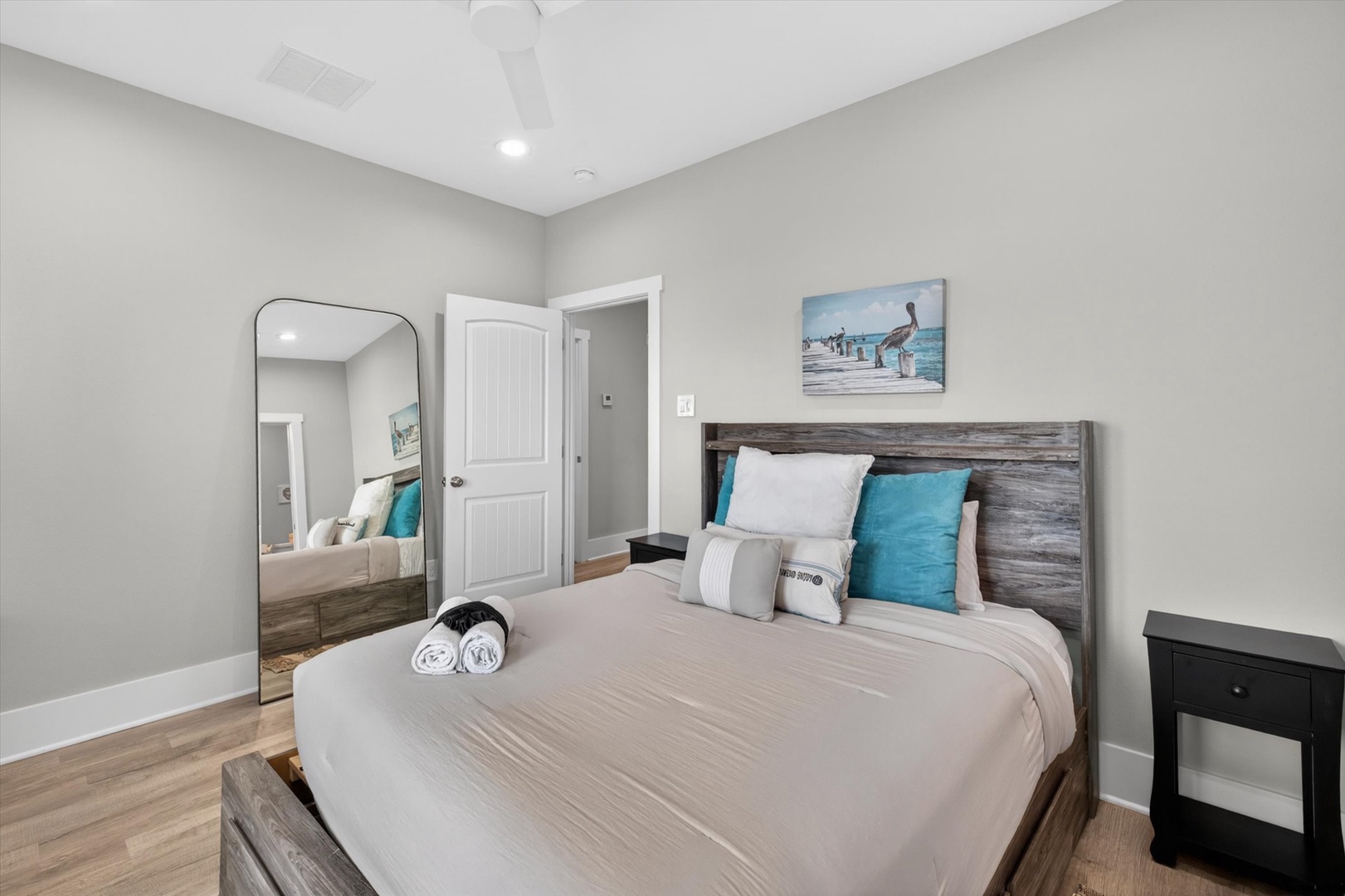 Soft lighting and coastal art create a peaceful retreat.