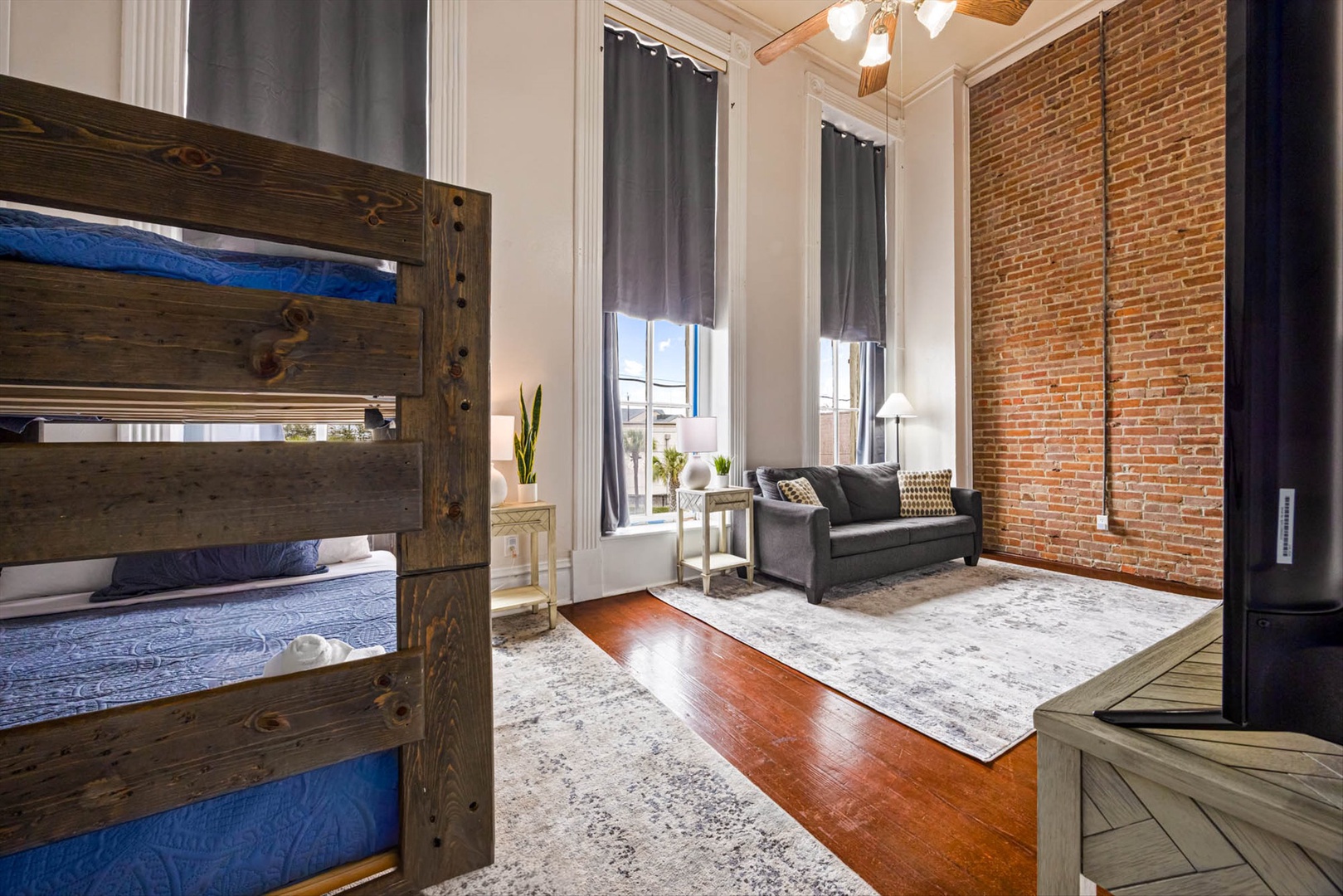 Urban loft with exposed brick, soaring ceilings, and bunk beds.