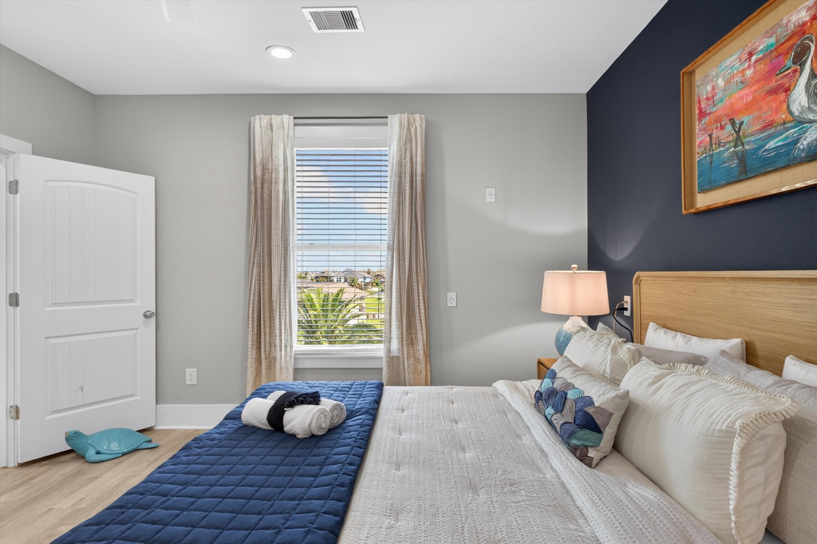 Relaxing bedroom with soft linens and neighborhood views.