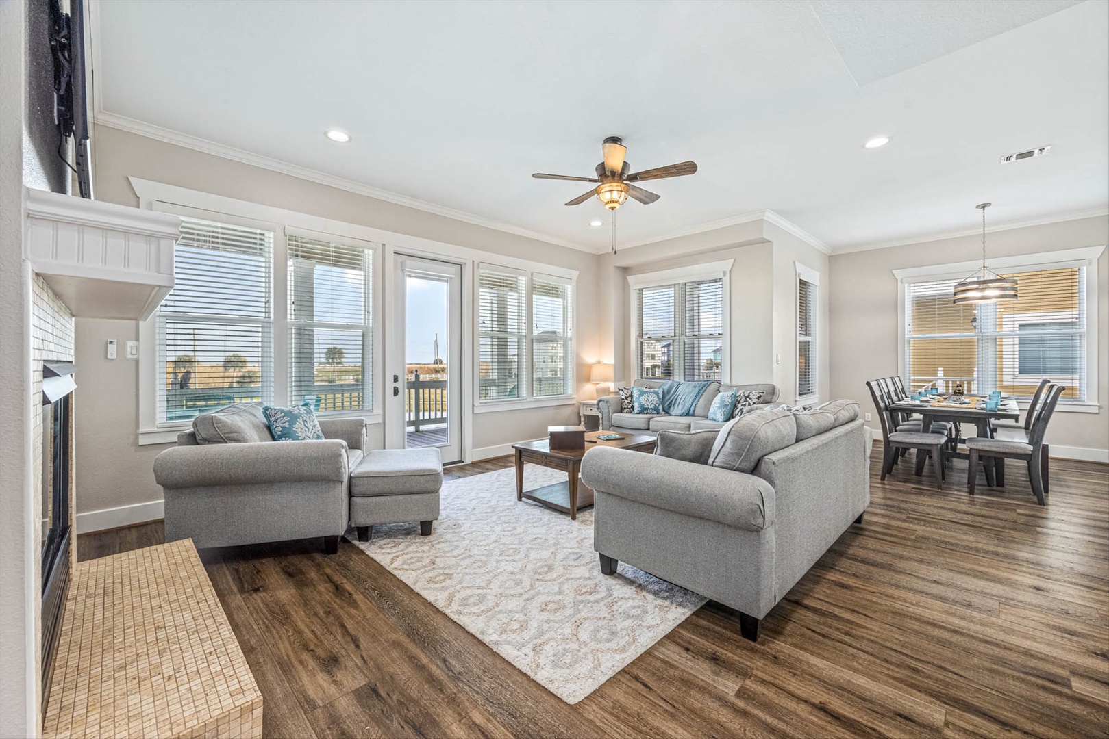 Relax in a bright living area with gray sofas and views.