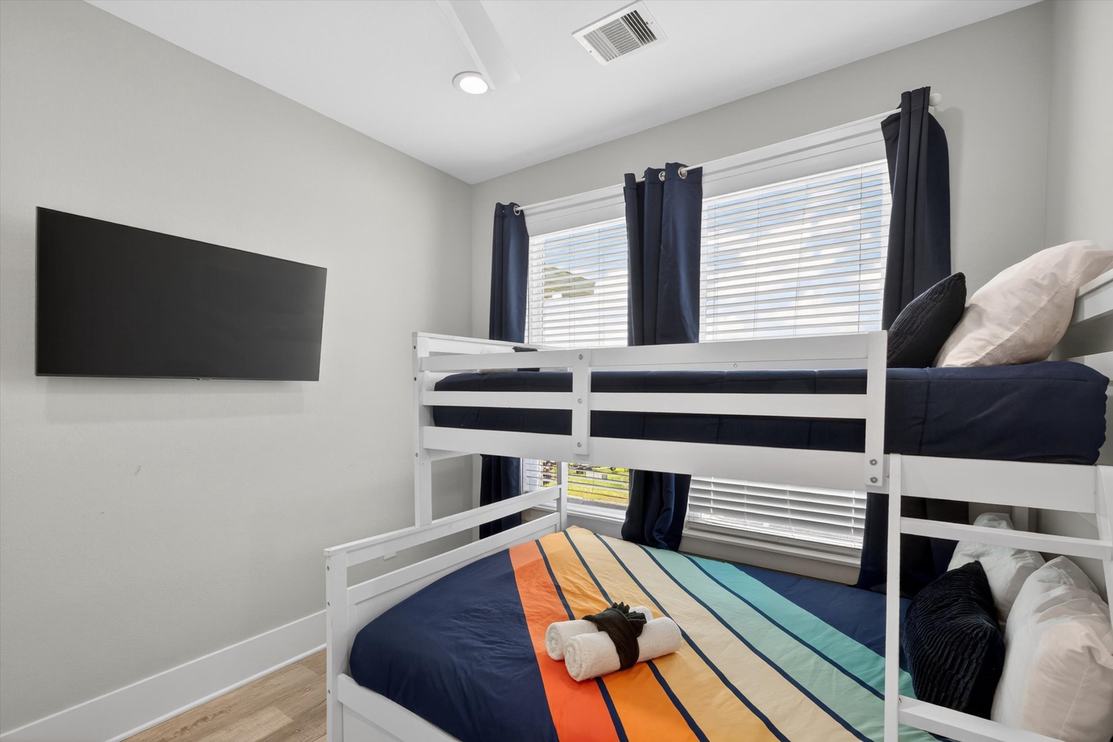 Adventure-ready bunk room with TV and comfy beds.