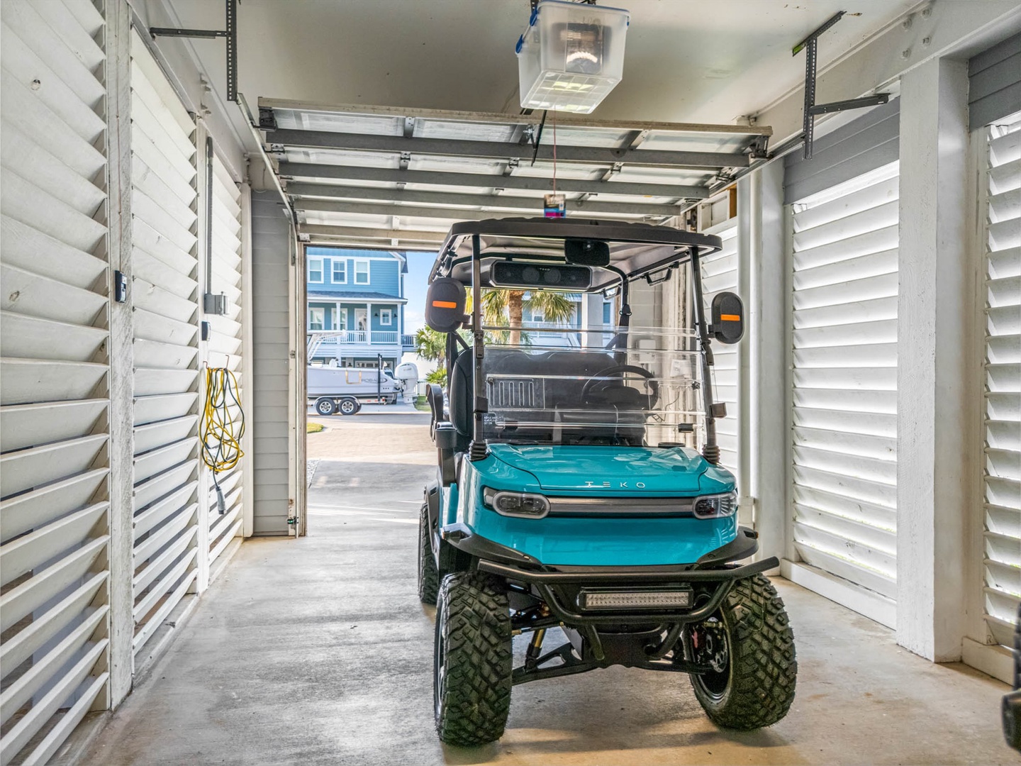 Covered garage with golf cart for fun and comfy rides.