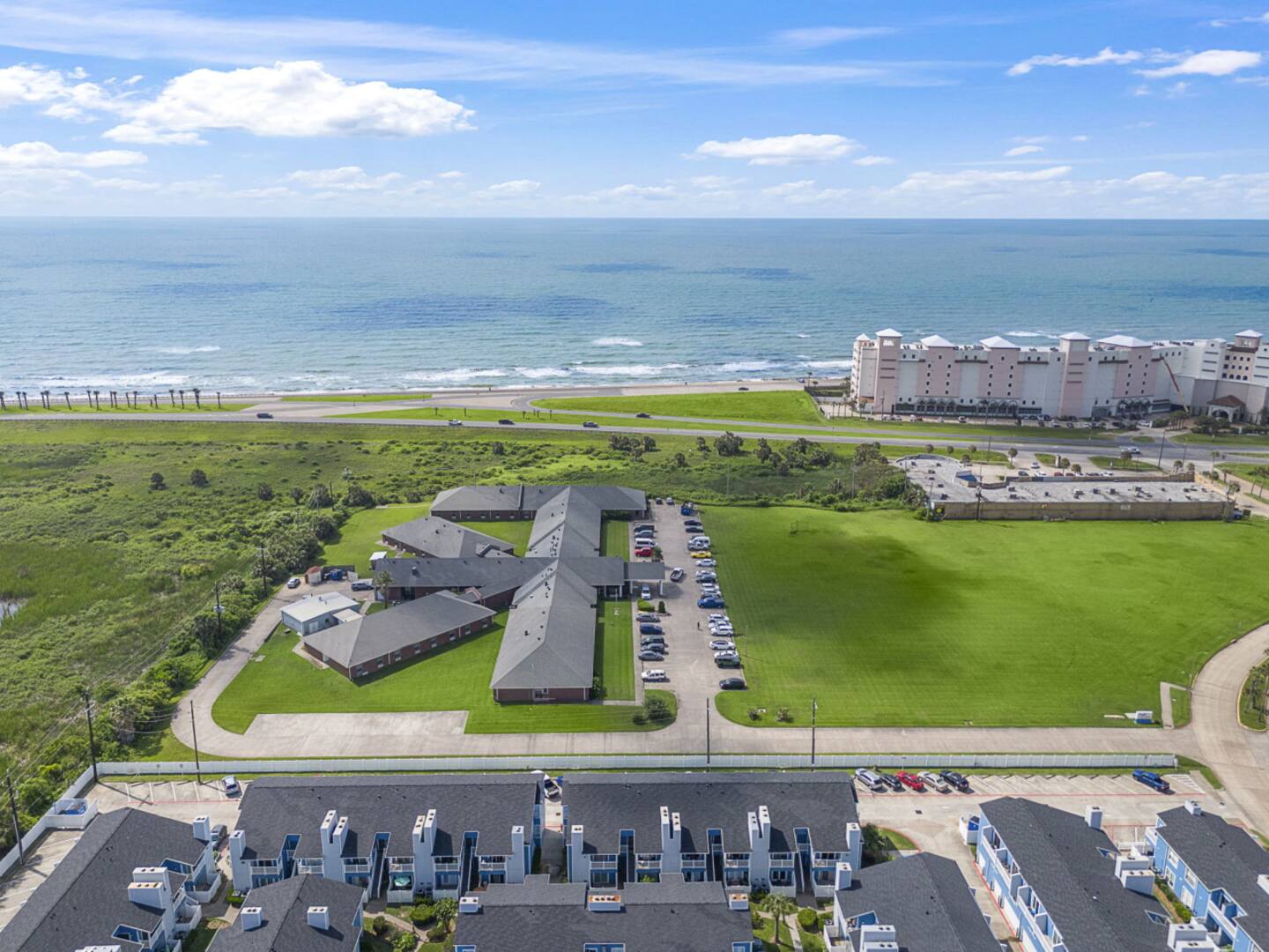 Aerial view with beach access and parking nearby.