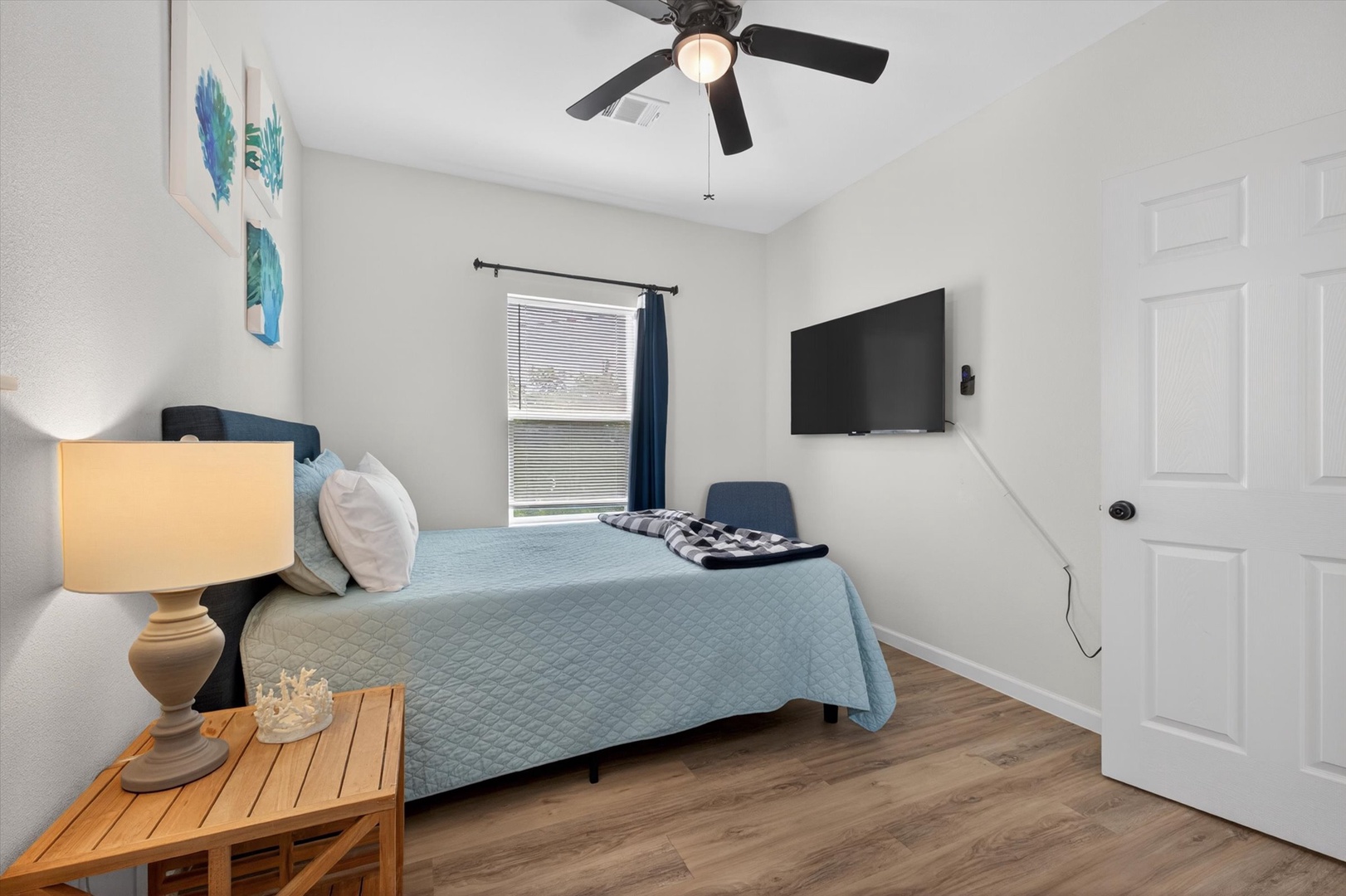 Relax in a cozy room with plush bed and TV.
