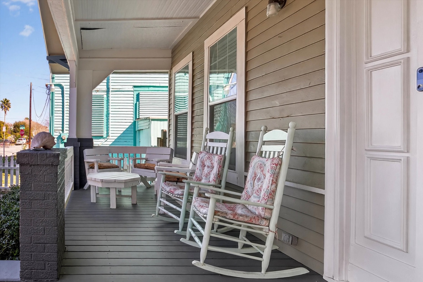 Unwind on your private porch with comfortable rocking chairs, perfect for morning coffee or evening relaxation while taking in neighborhood views.