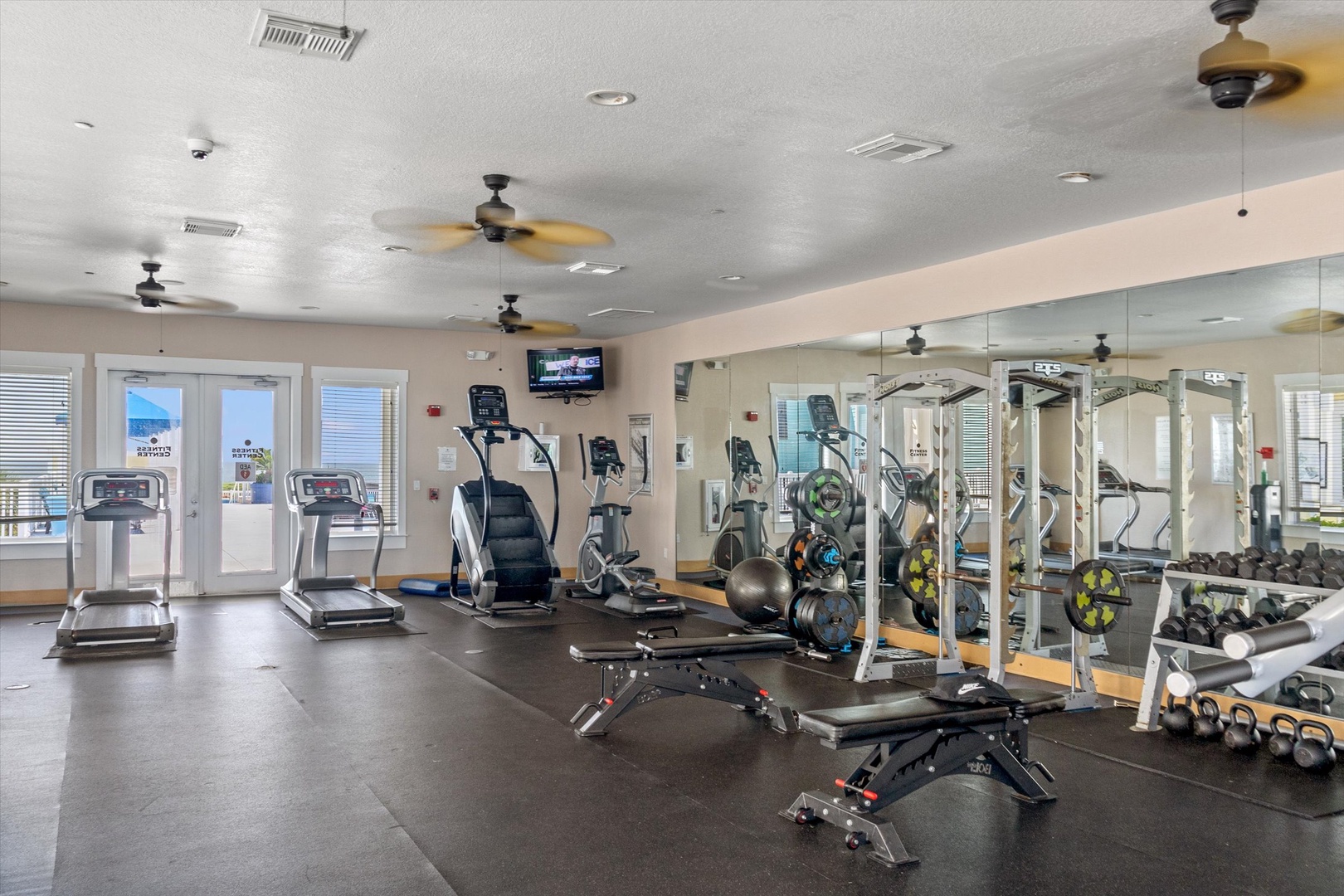 Resort gym with machines, weights, and training stations.