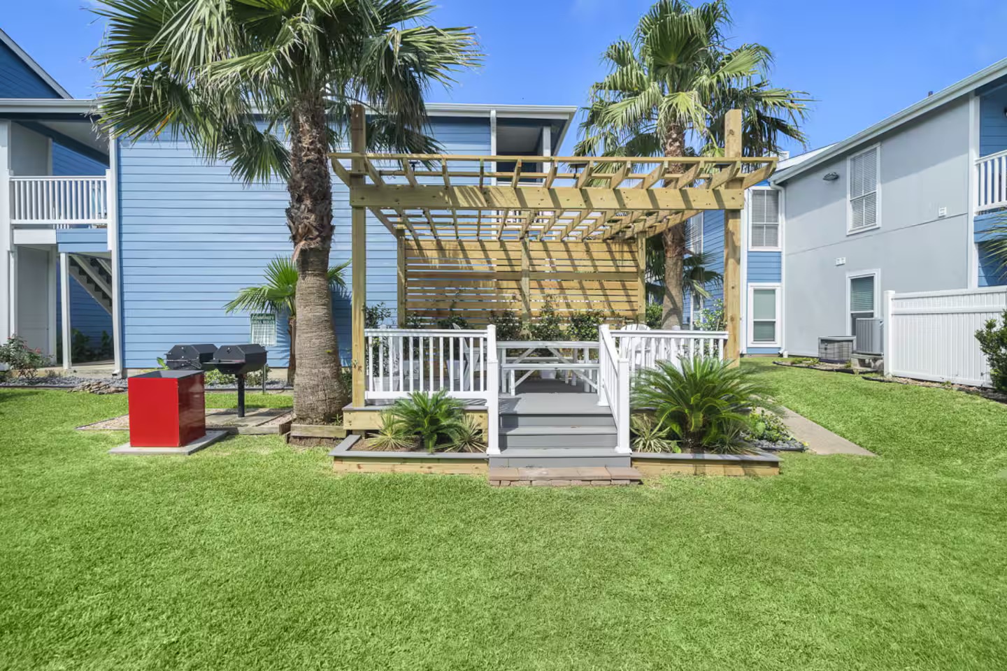Outdoor oasis with BBQ, palms & pergola seating