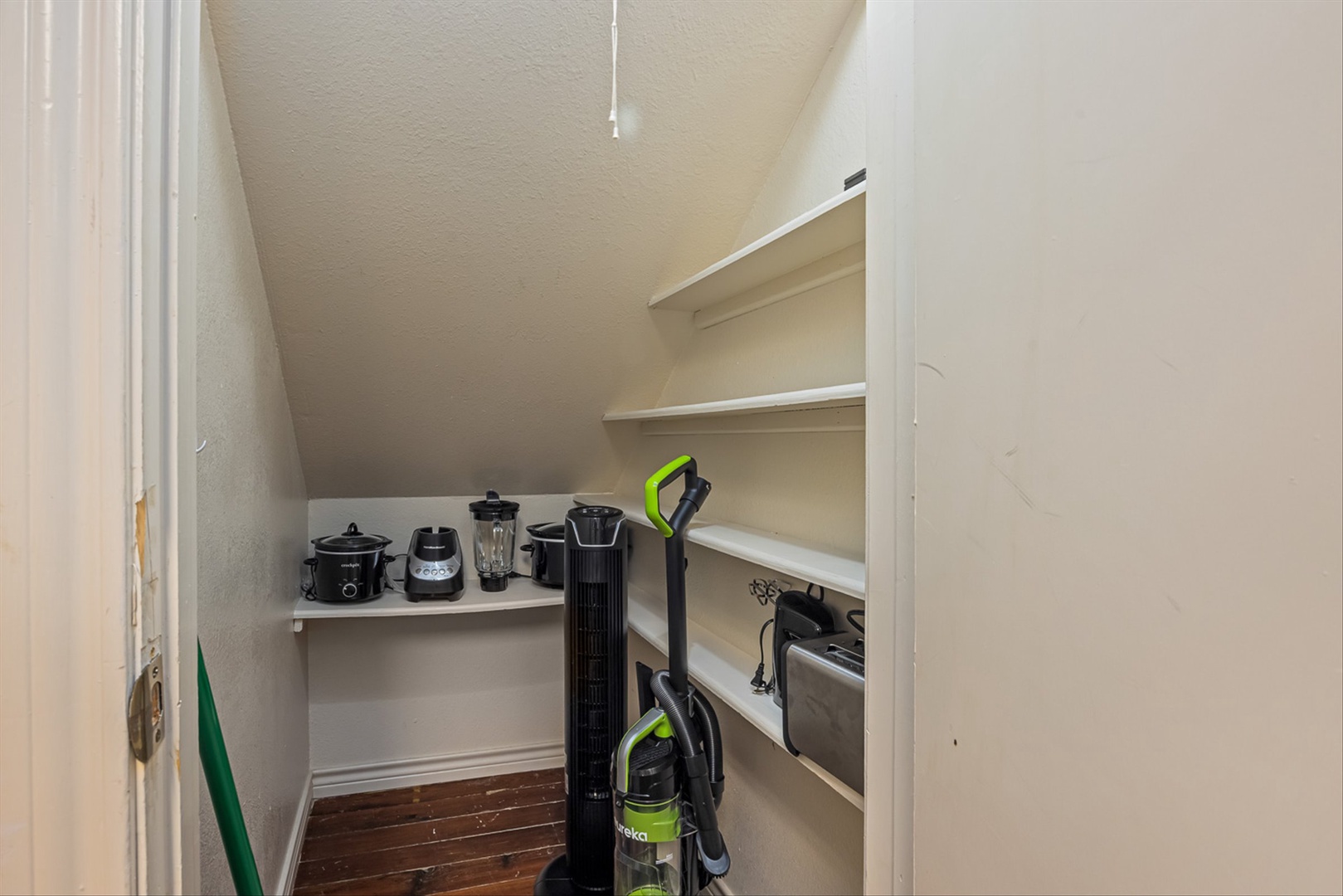 Private pantry with organized shelving for appliances and supplies.